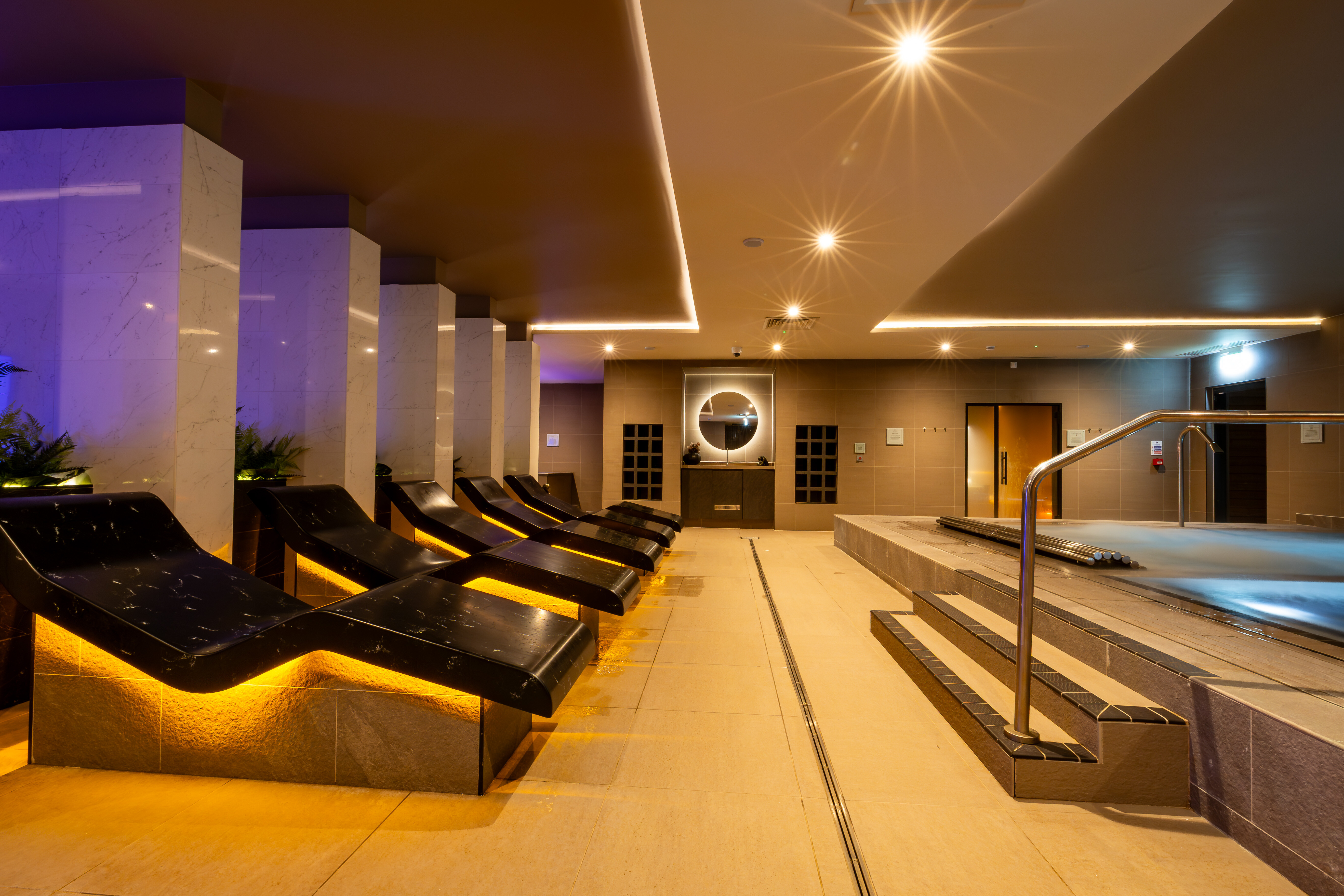 Curved heated loungers and a hydropool