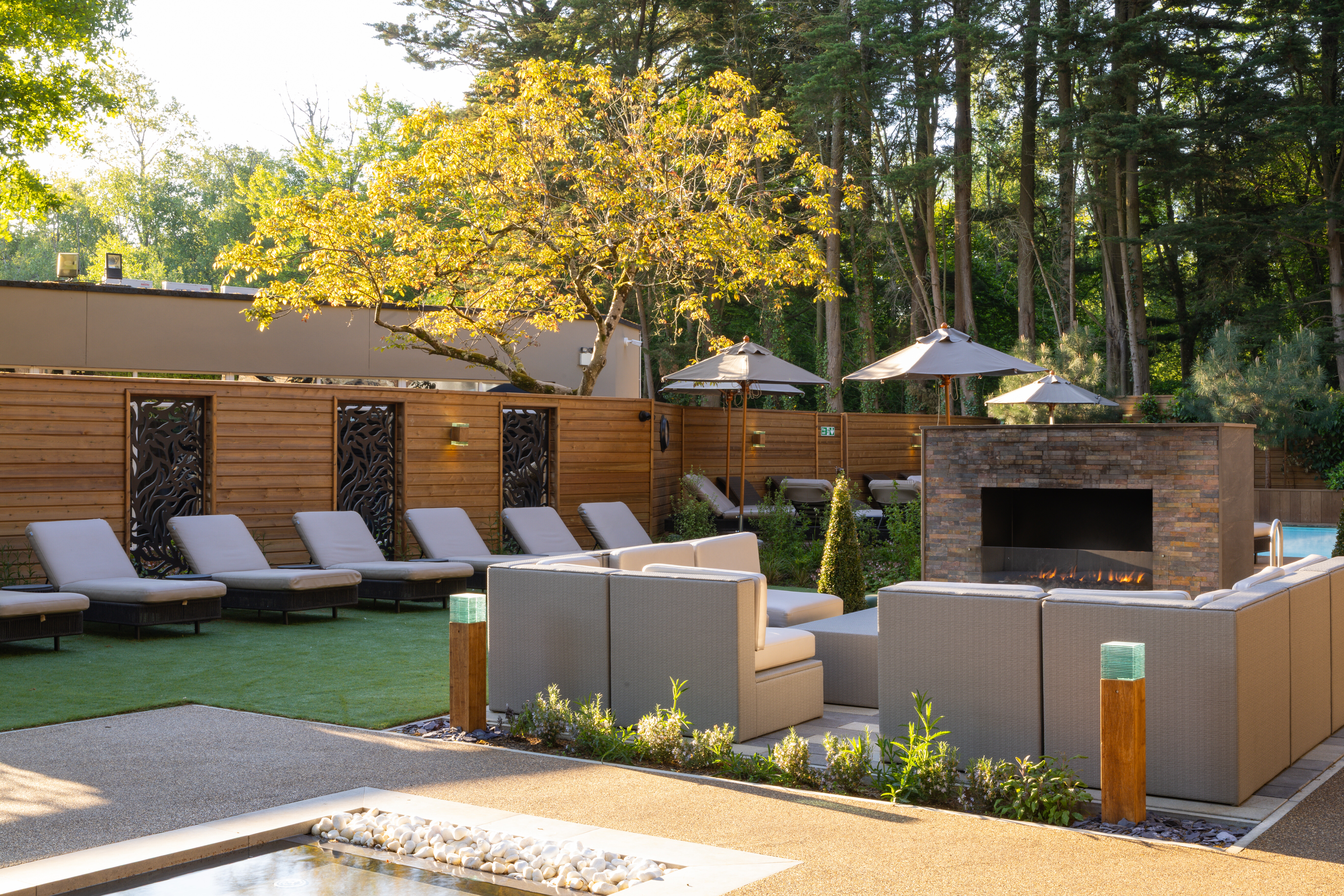 Outdoor Spa Garden seating area with sofas and loungers
