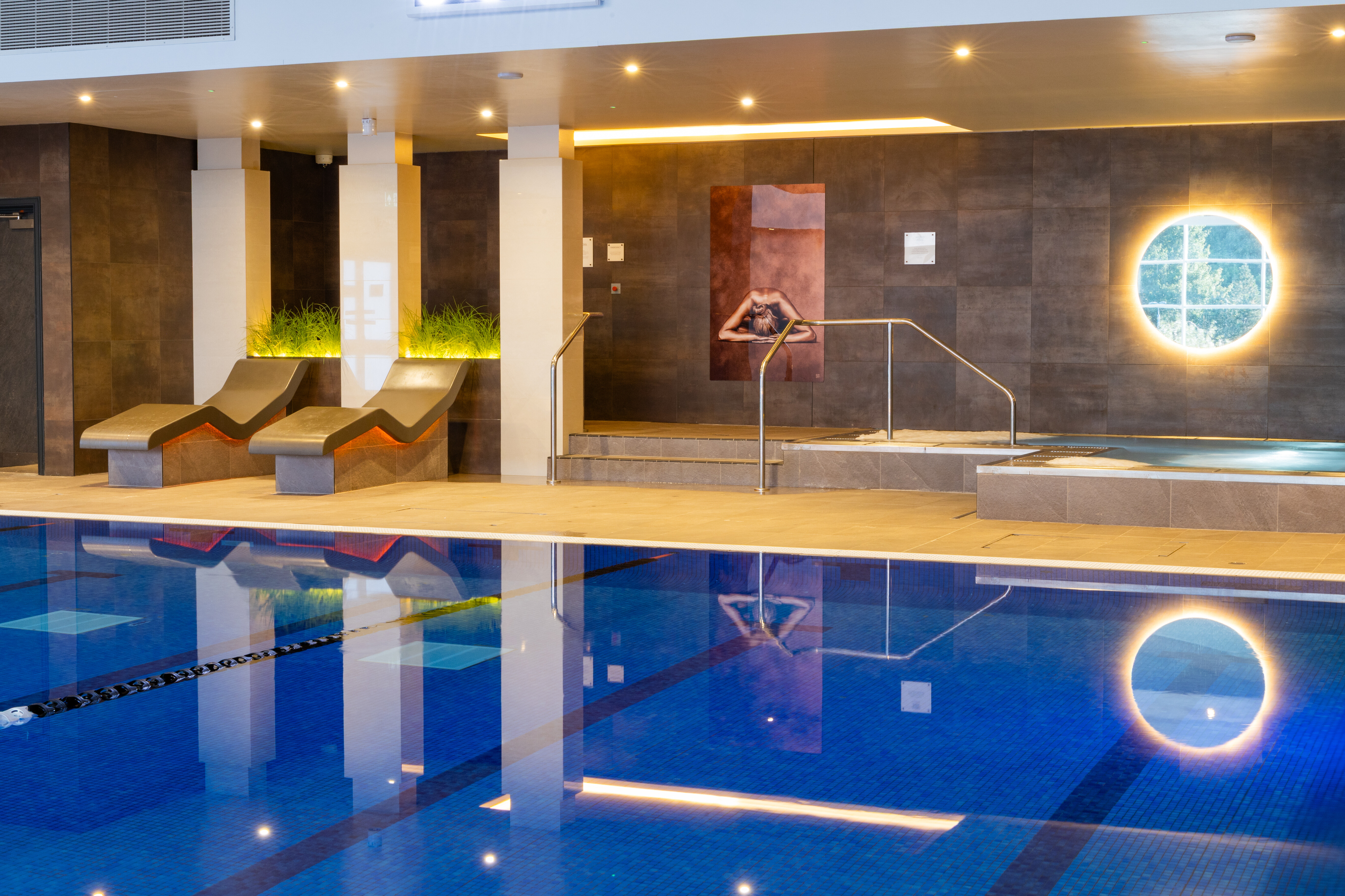 Inviting pool water in front of loungers and a soothing jacuzzi
