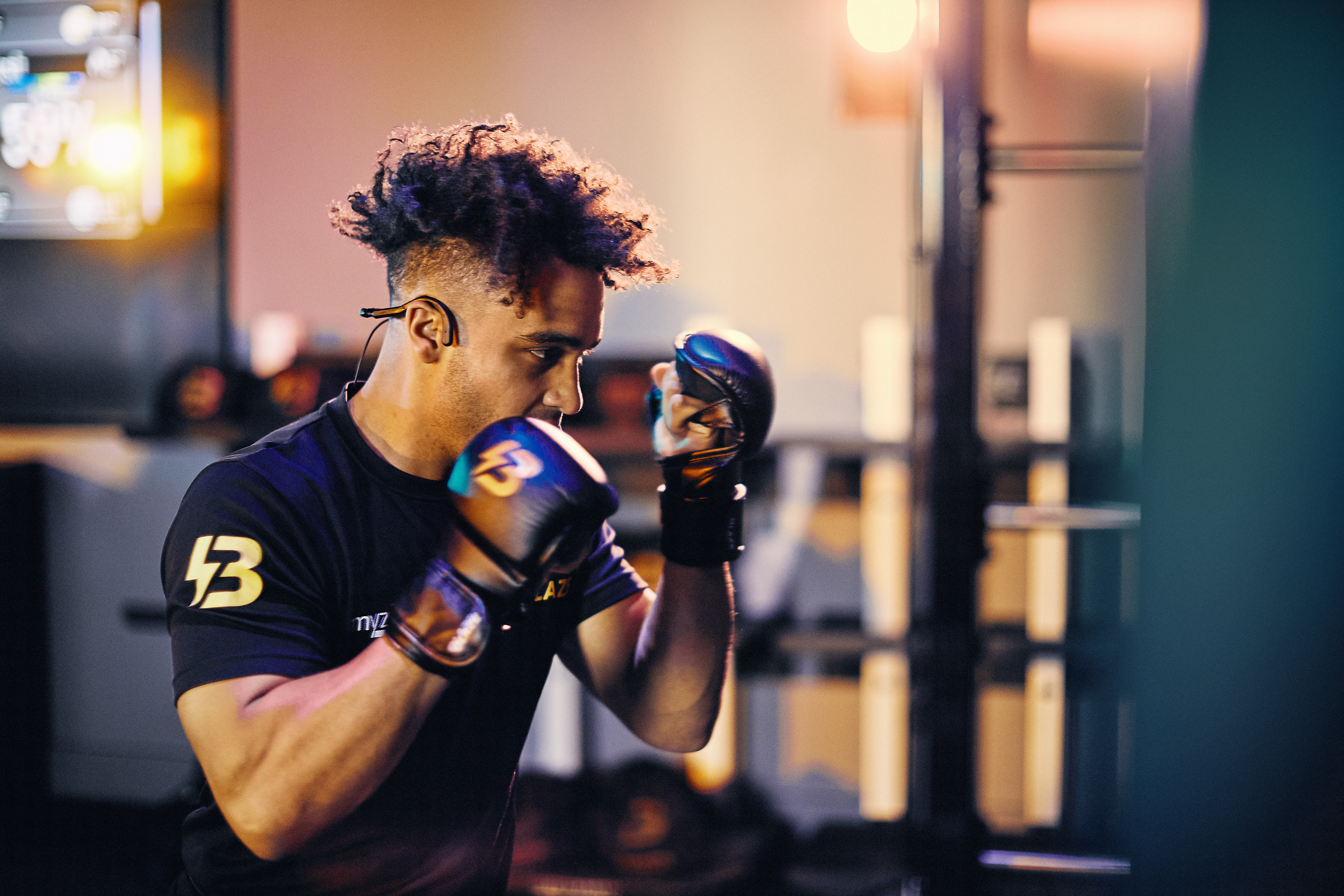A man wearing boxing gloves in a Blaze class