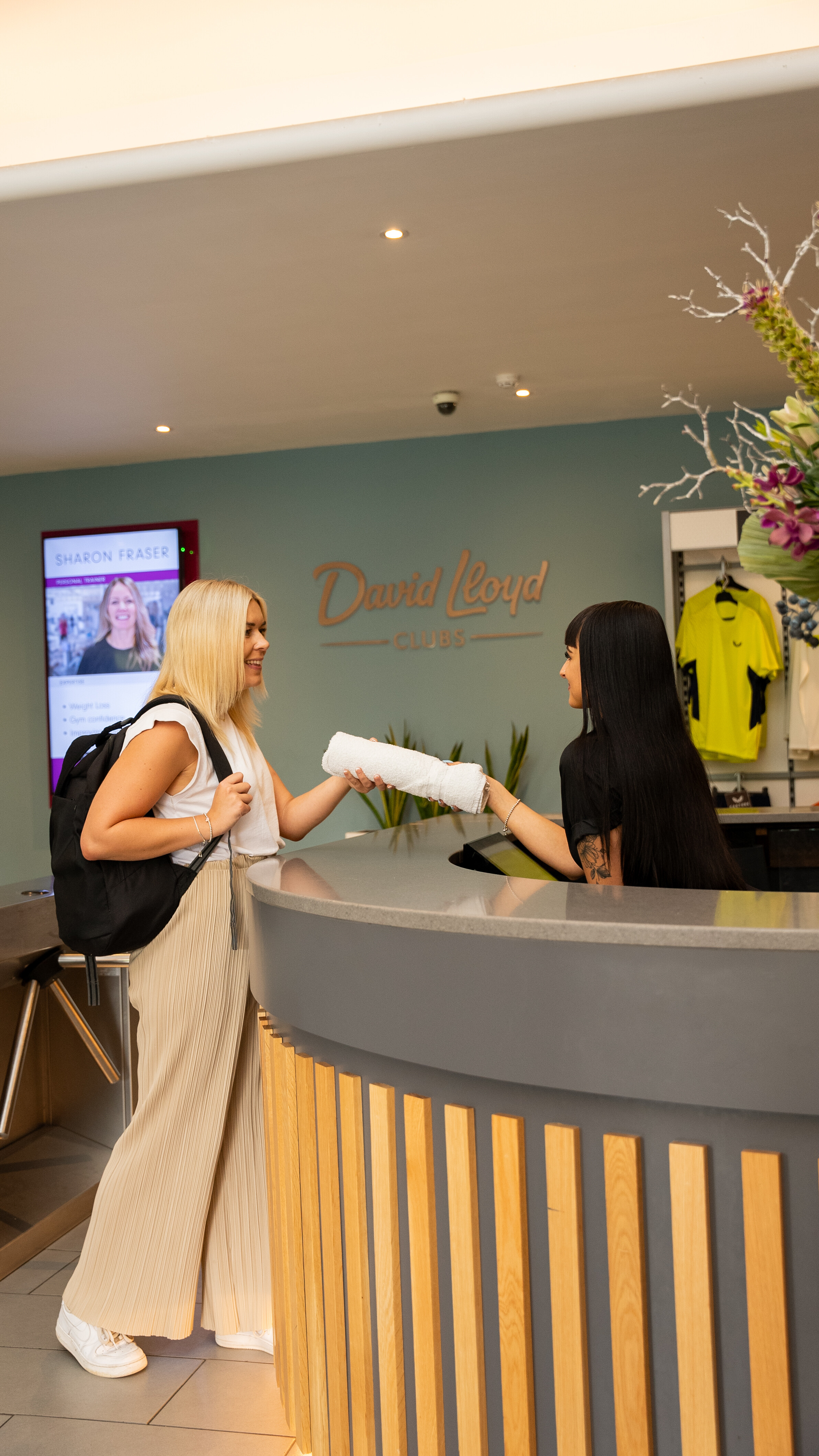A woman is greeted by a receptionist
