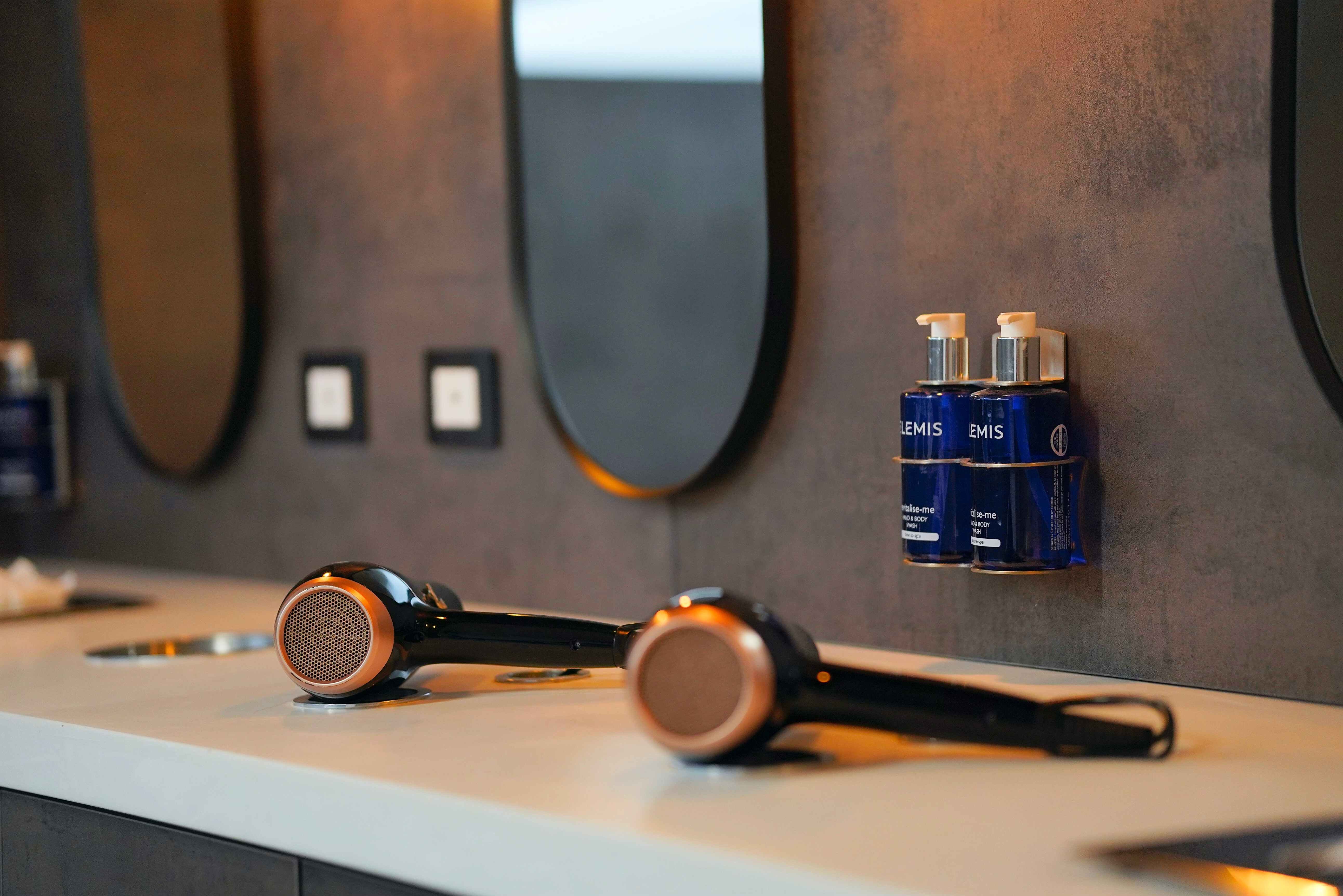 Hairdryers and products in front of mirrors