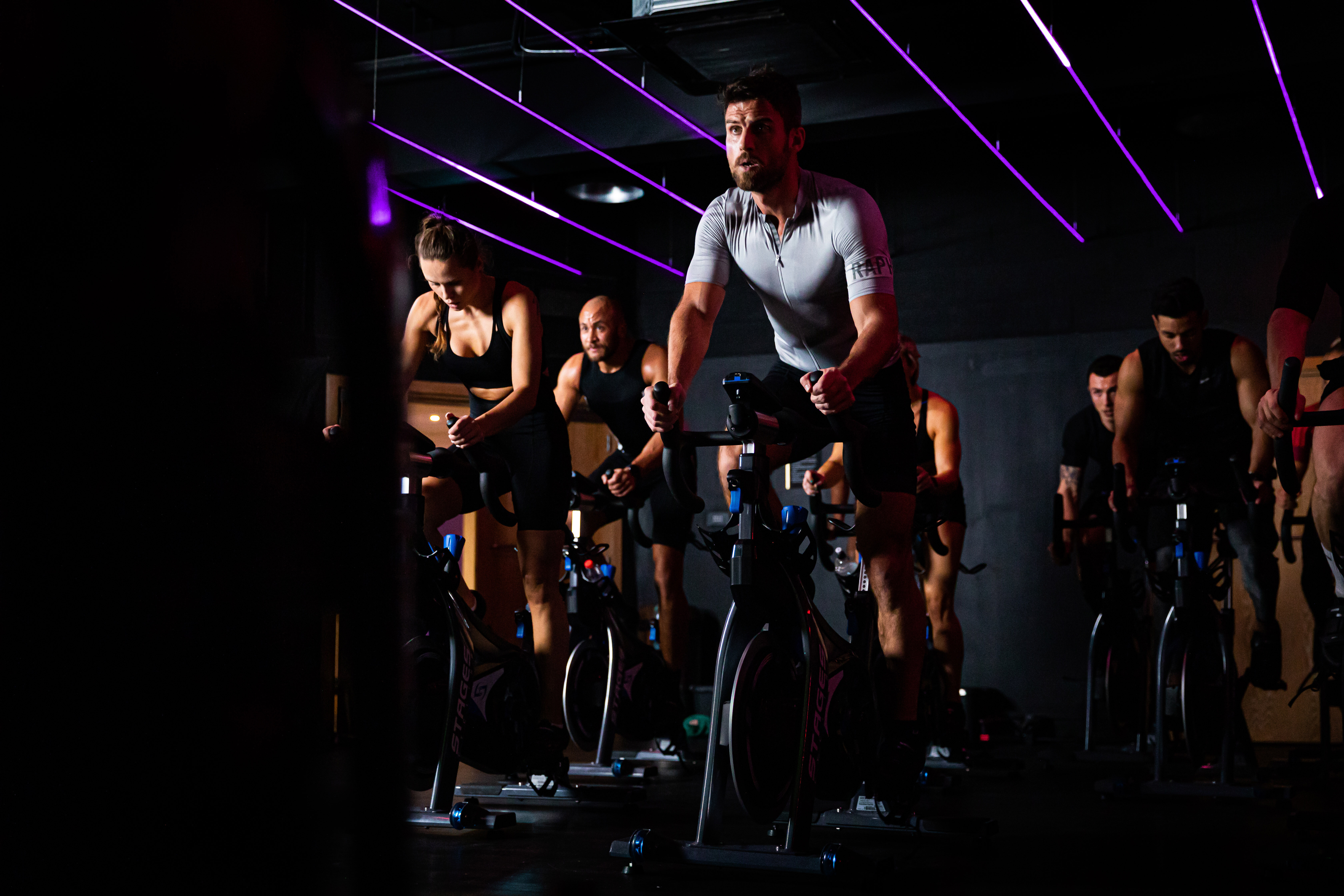 A spin class working hard on the bikes