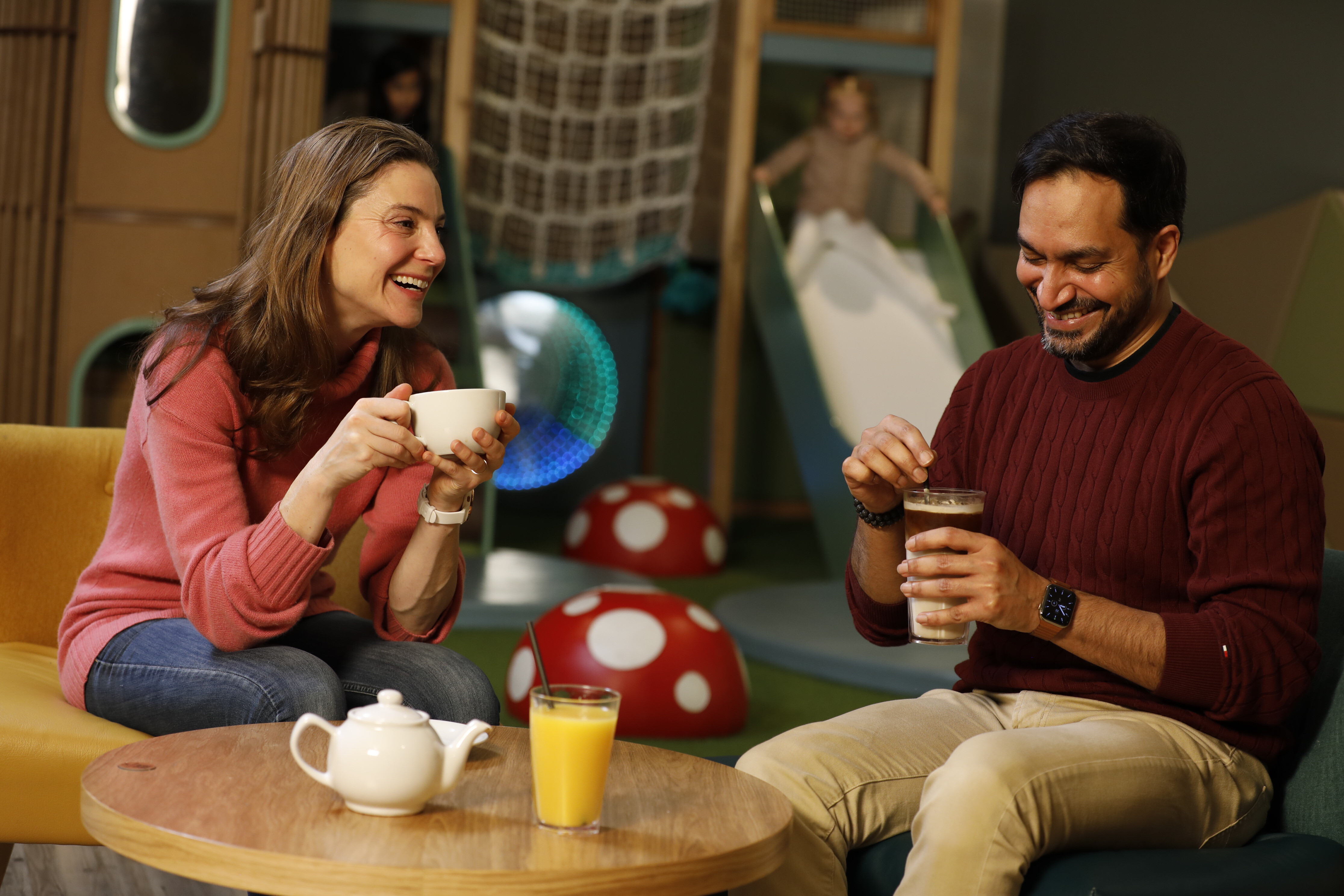 A man and woman enjoying a drink in the Clubroom
