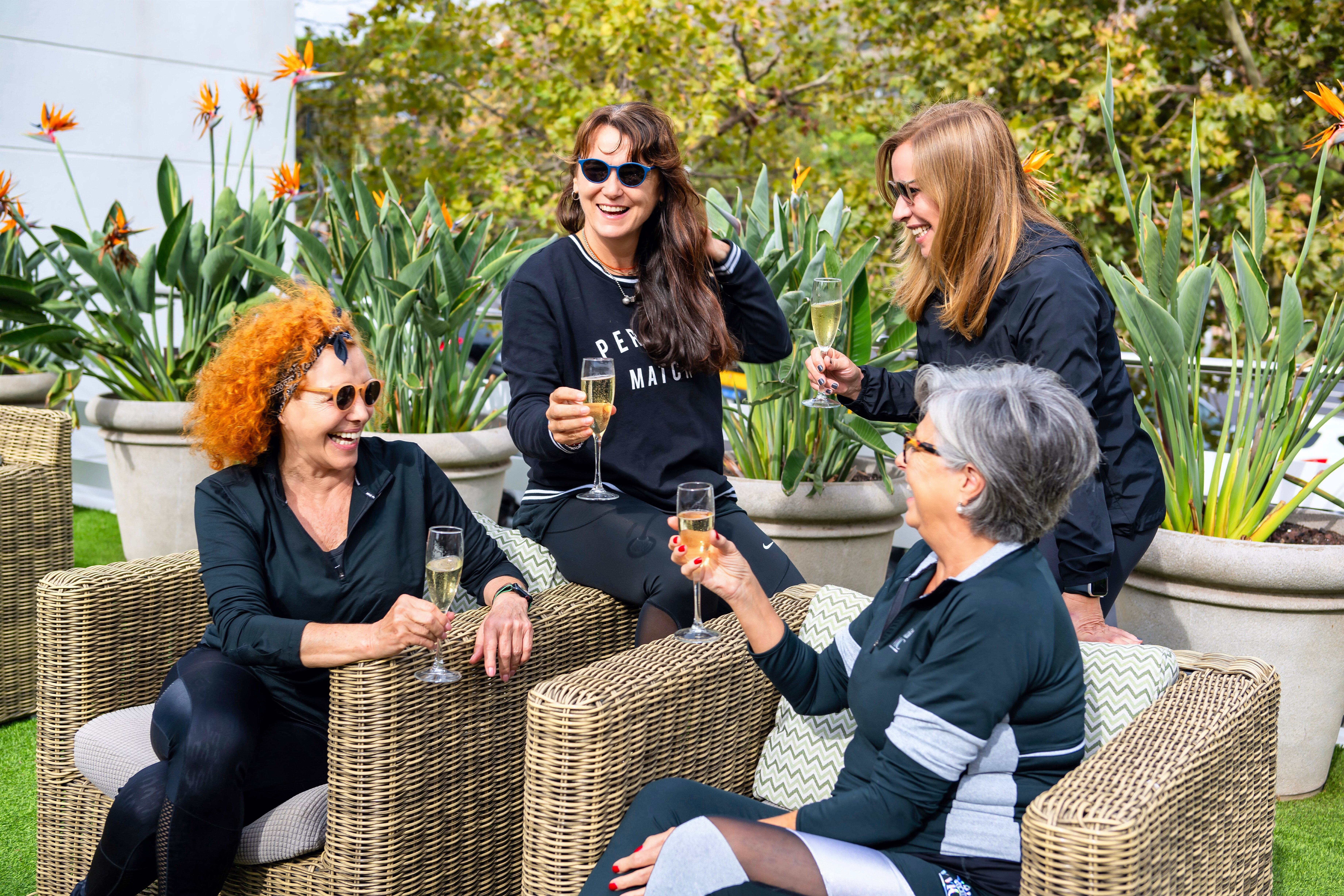 A group of four people enjoying a glass of fizz on the terrace
