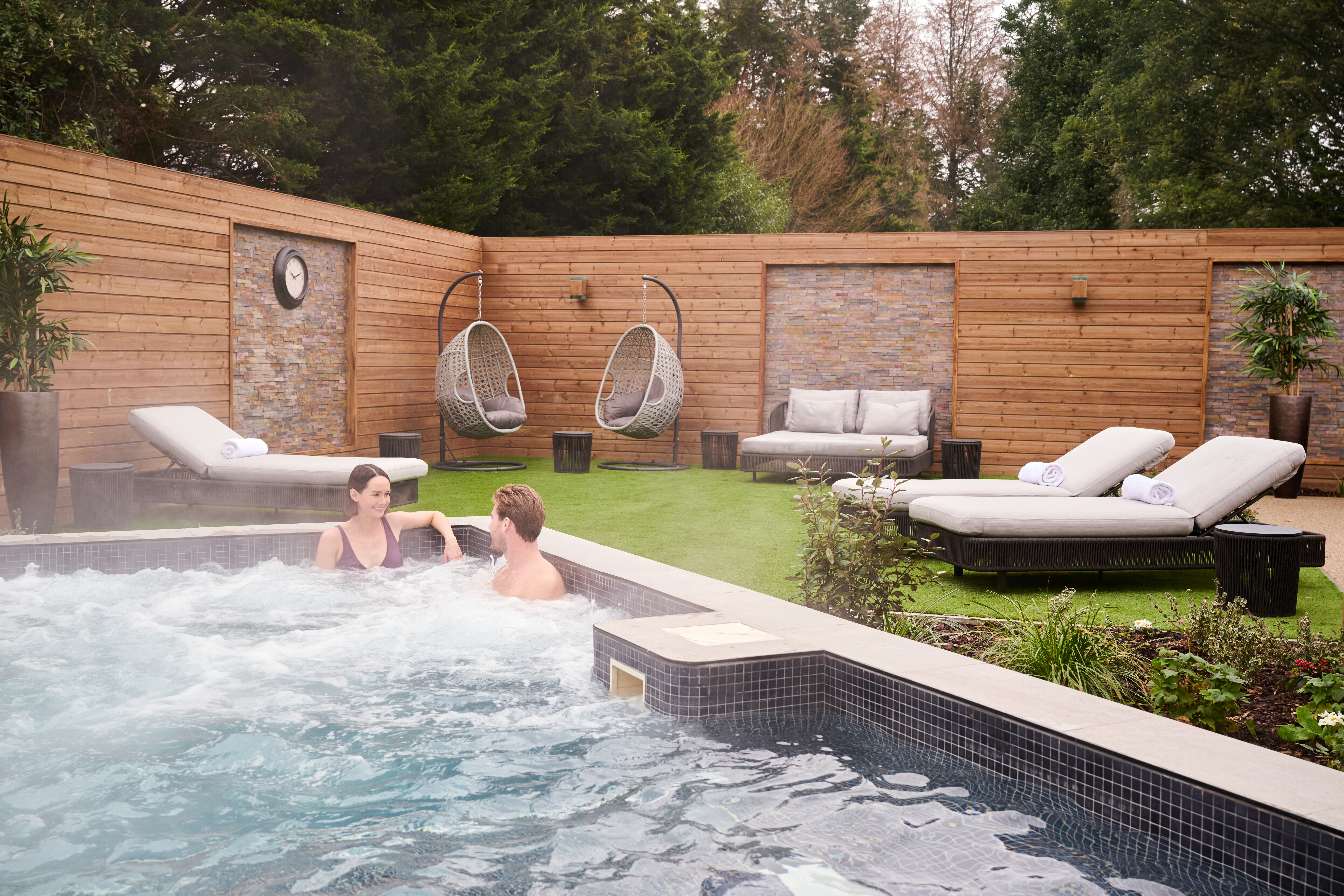 Two people relaxing in the tranquil surroundings of our Spa Garden