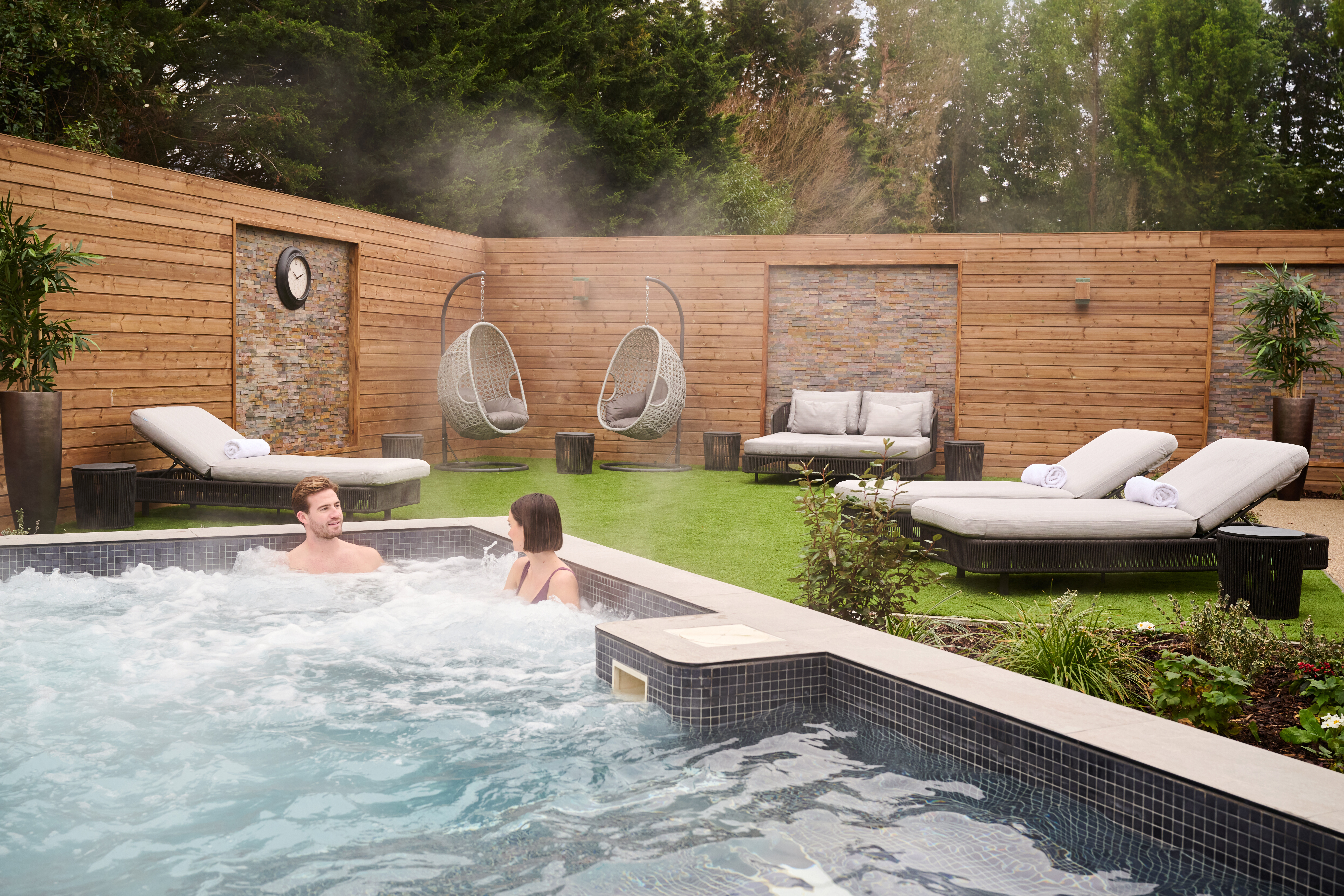 A man and a woman in the outdoor hydro pool