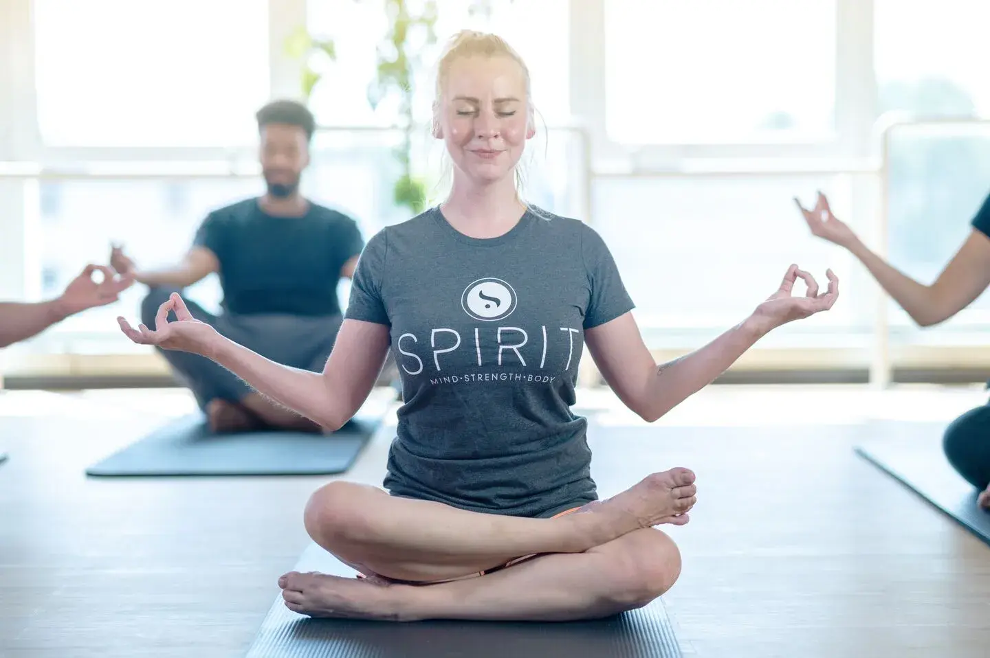 People meditating in a yoga class.