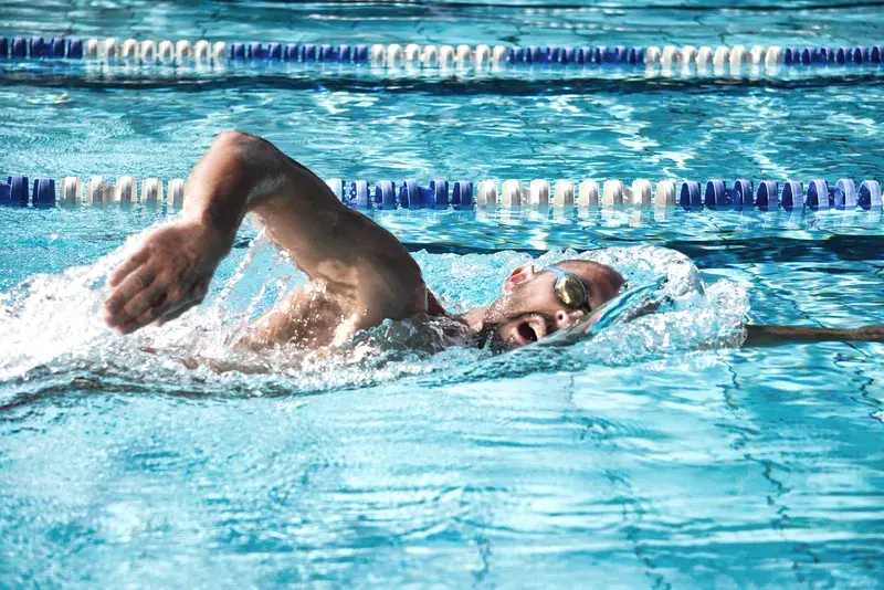 A man swimming front crawl
