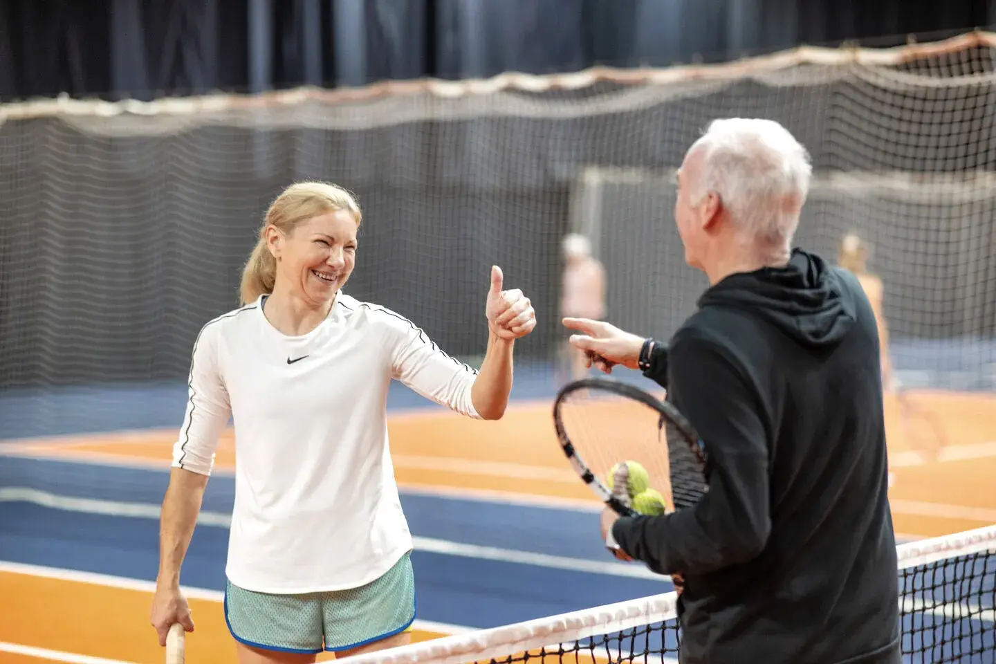 Two people playing tennis