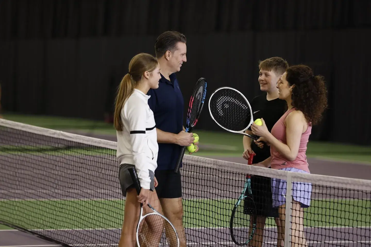 Family on tennis court