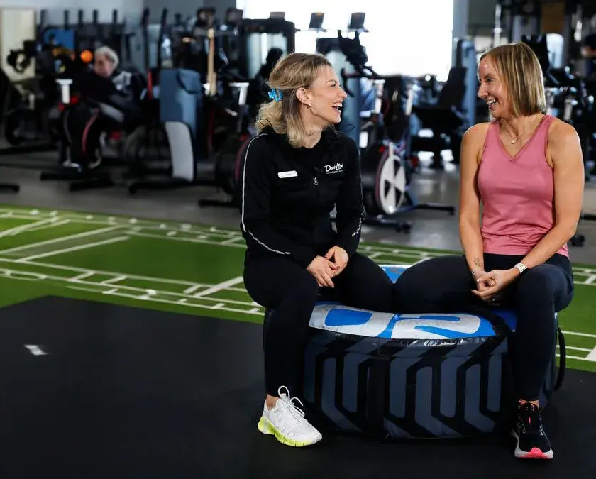 A woman relaxing with a personal trainer