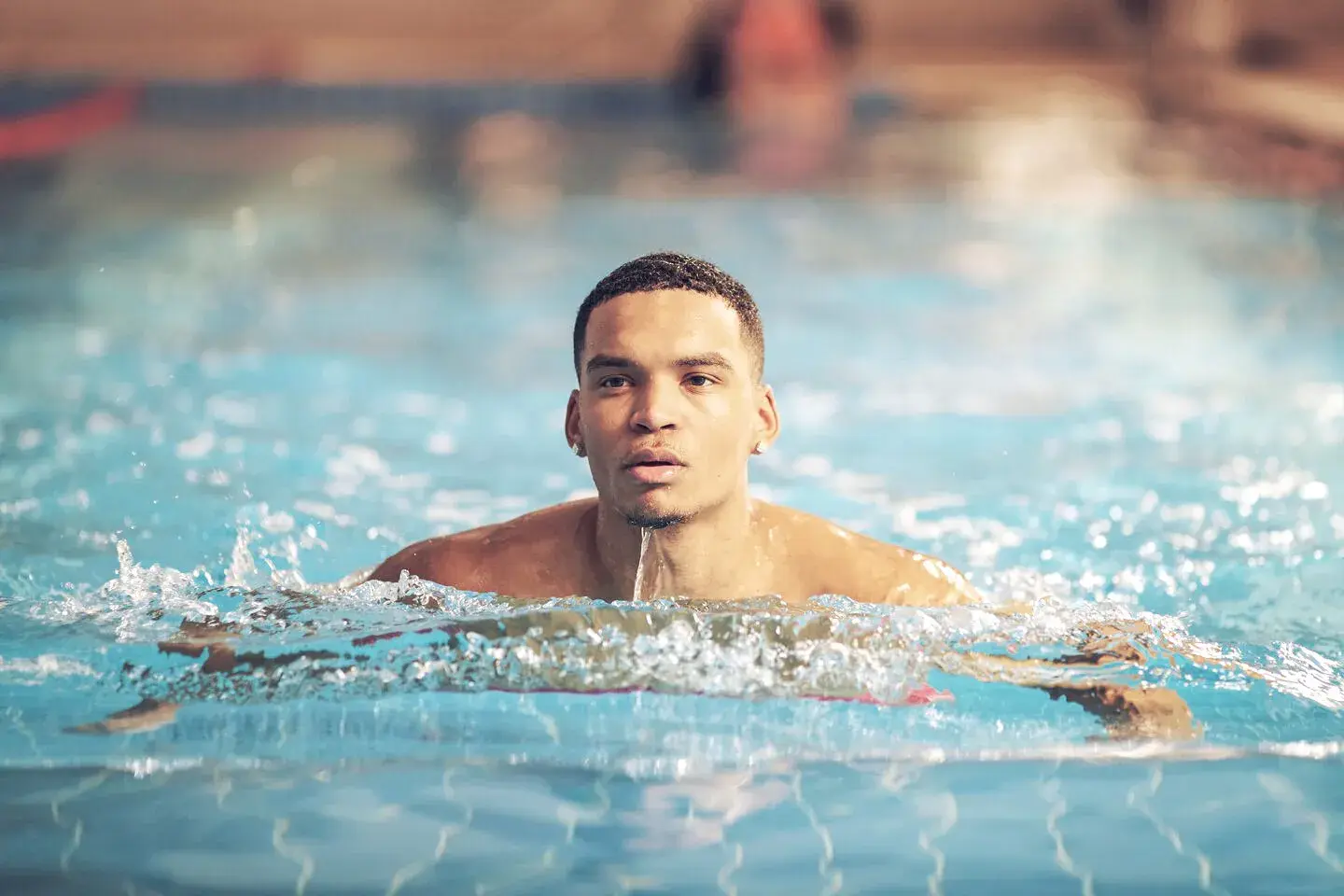 Man swimming in a pool at a David Lloyd Club