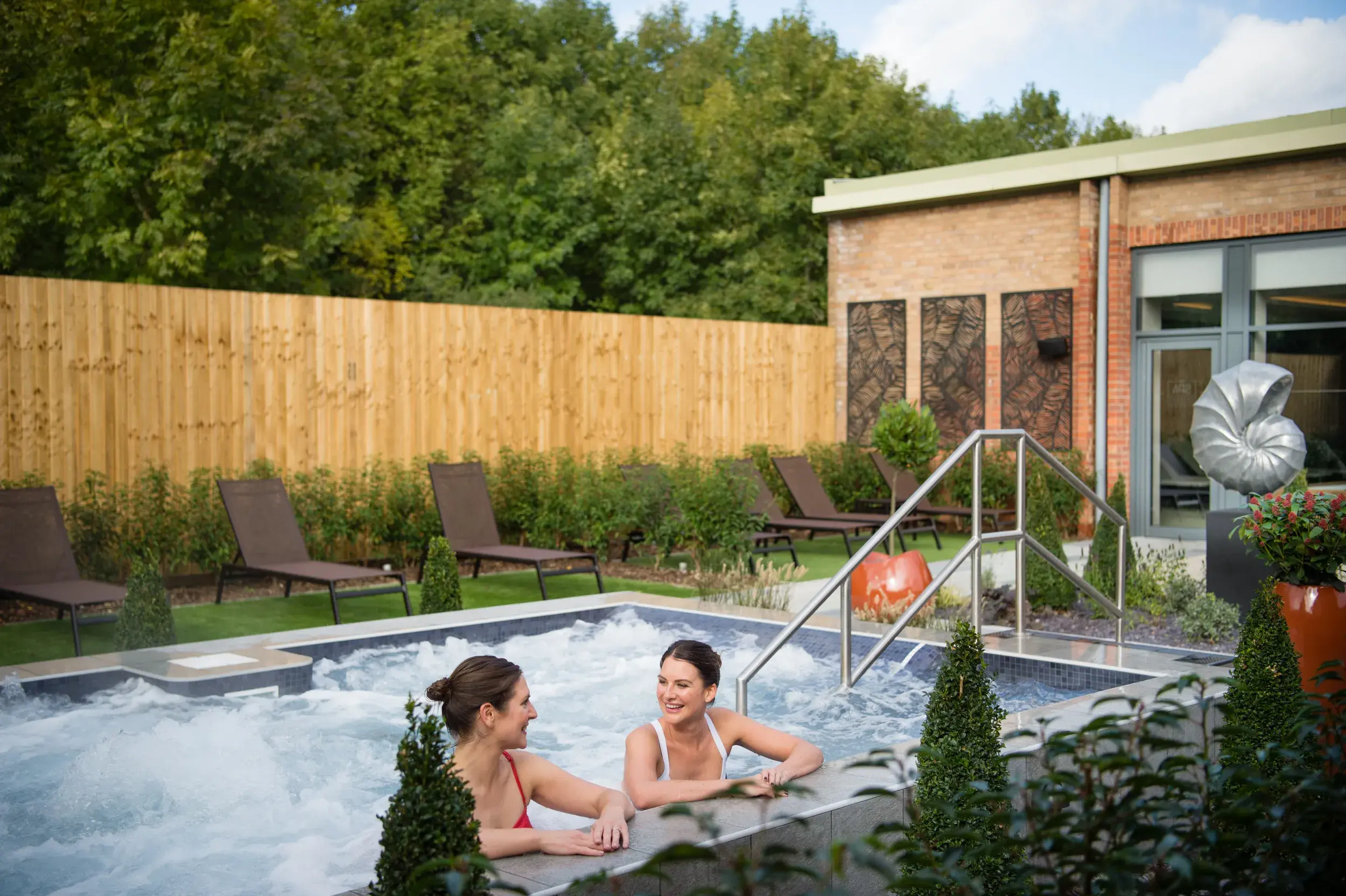 2 women in outdoor hydro pool