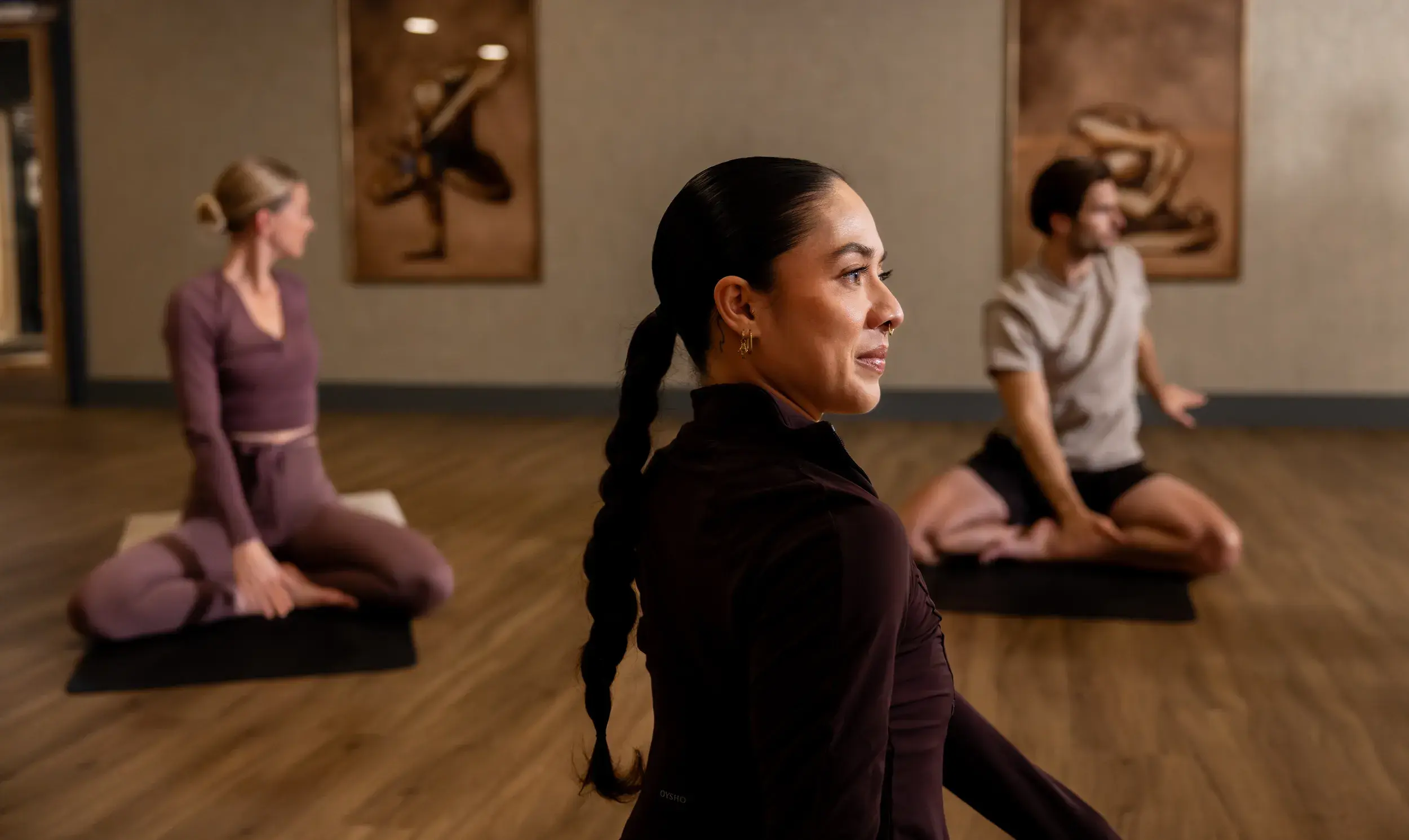 Three people doing mat Pilates