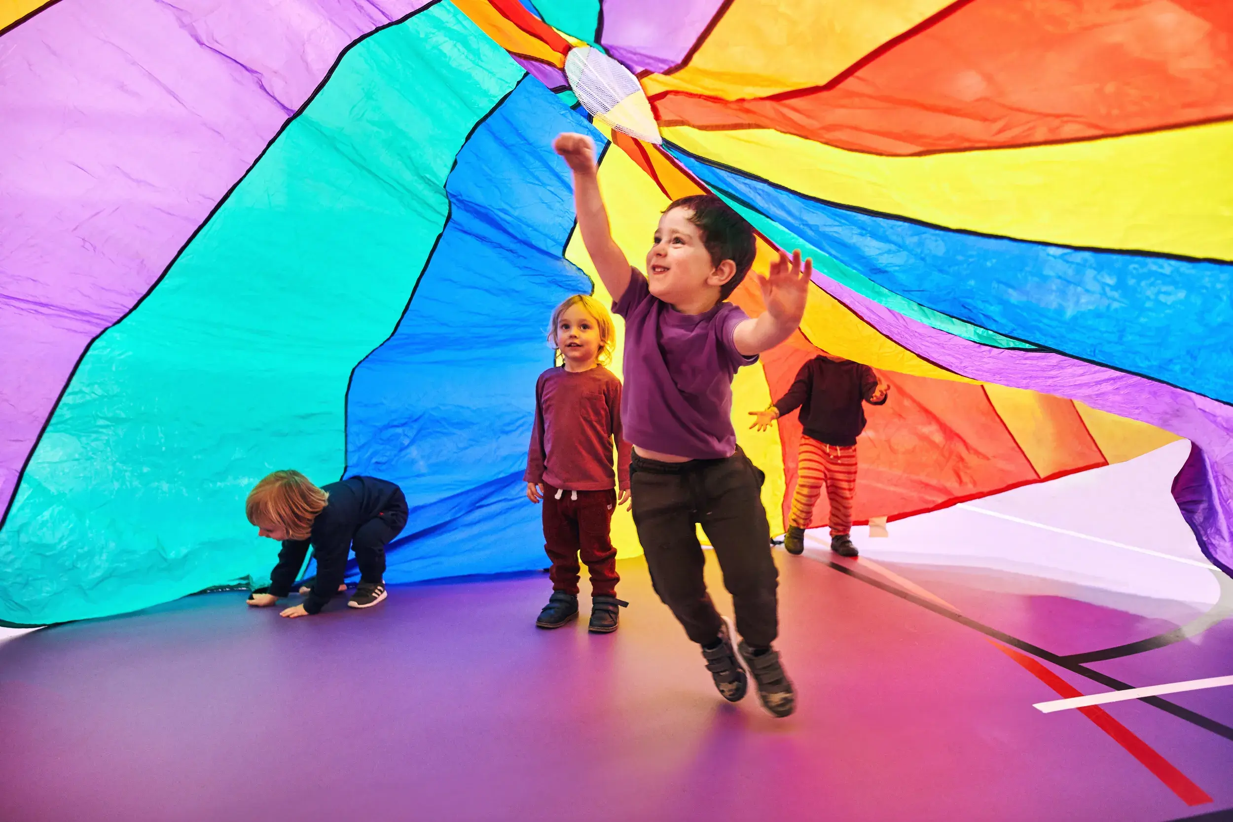 Children playing under a parachute