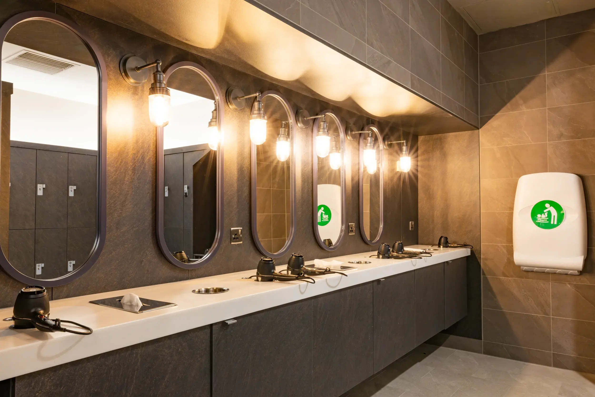 Vanity area with mirrors and hairdryers