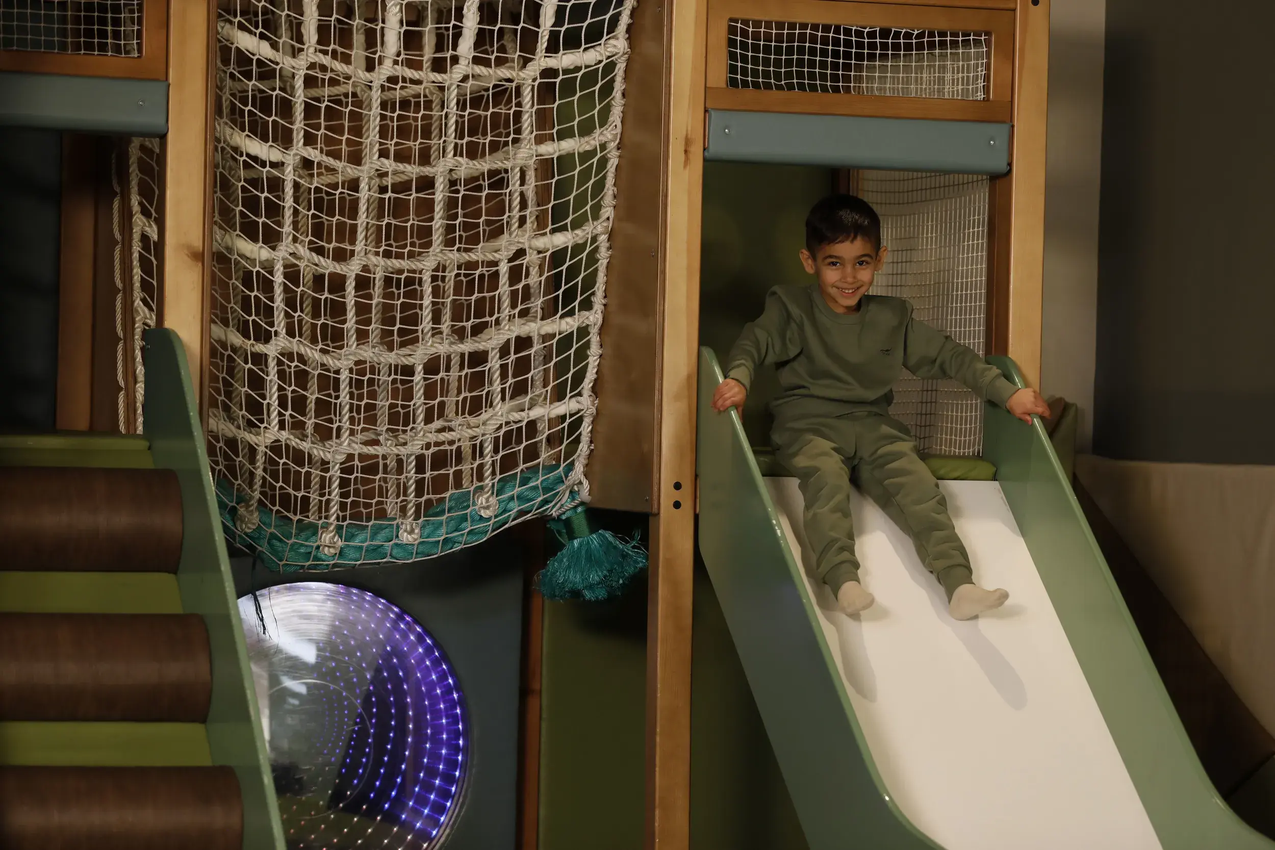 A child on the slide in the soft play area 