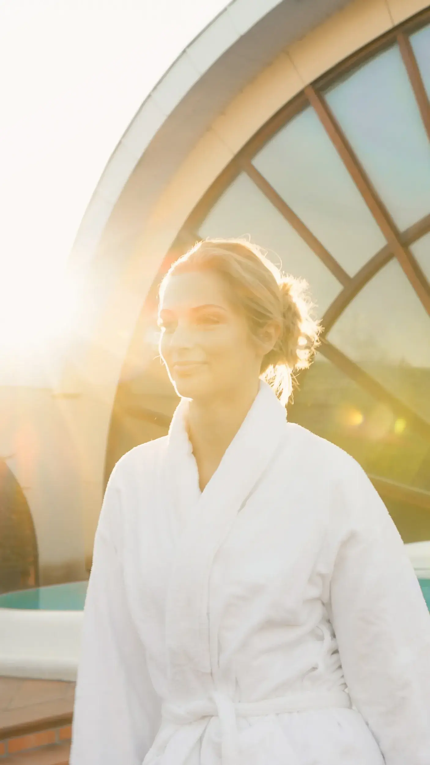 A woman standing with the sunlight in her face