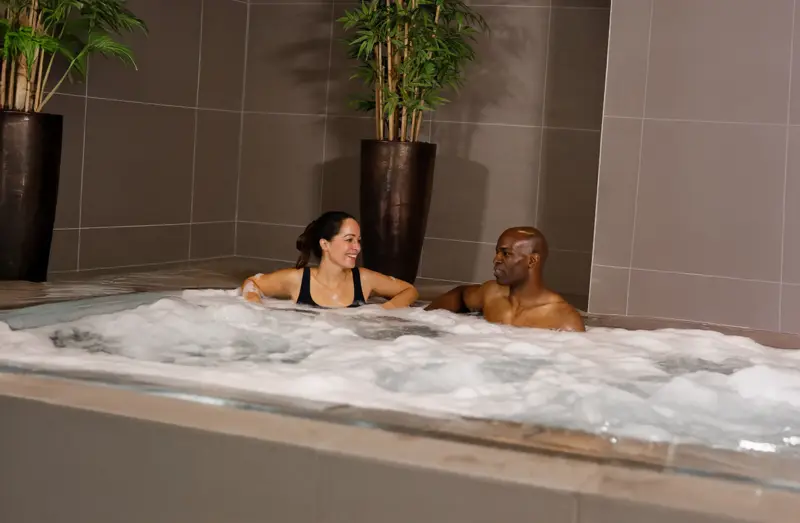 A man and woman relaxing in a whirlpool