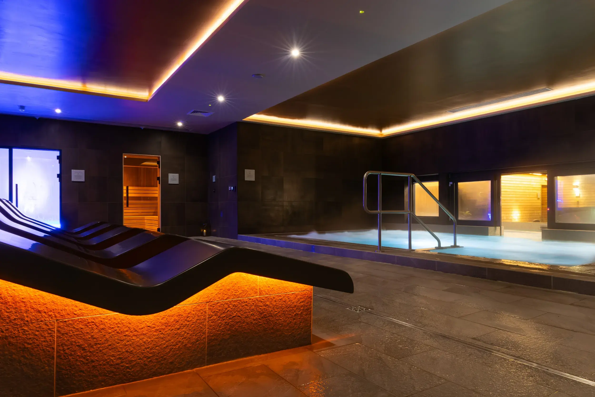 The indoor hydro pool and heated loungers