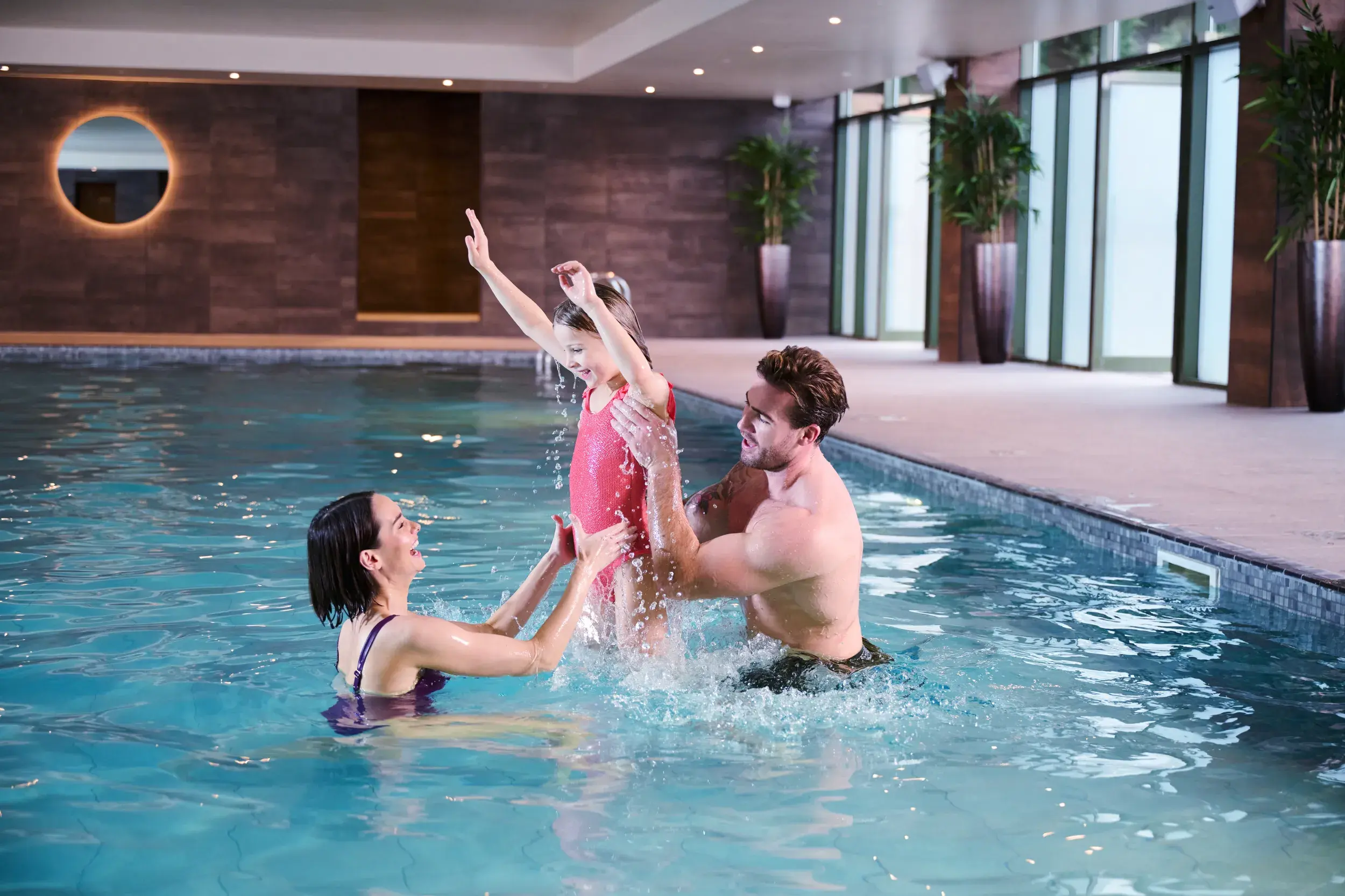 A family playing in the indoor pool