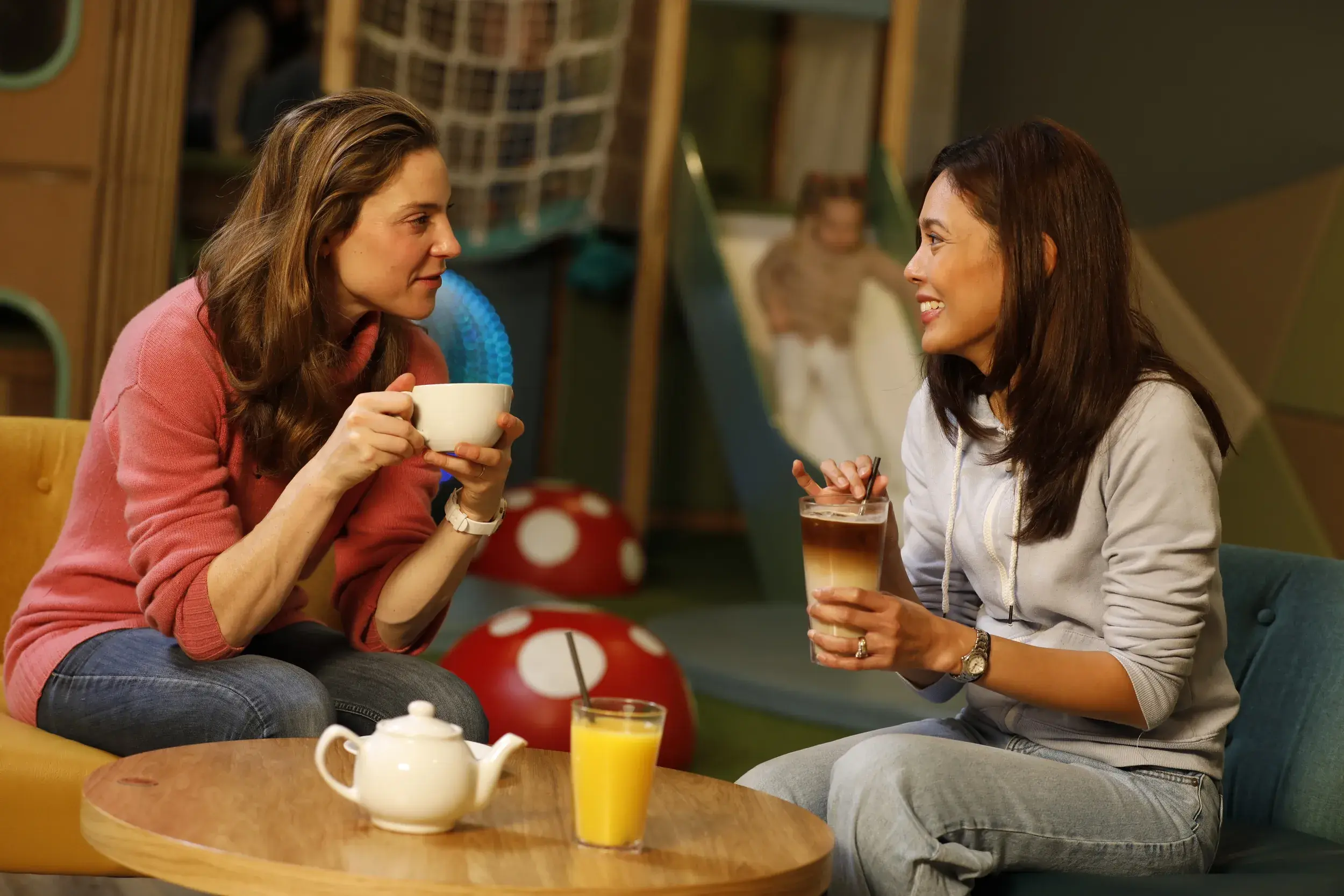 Two women enjoying a coffee in the Clubroom