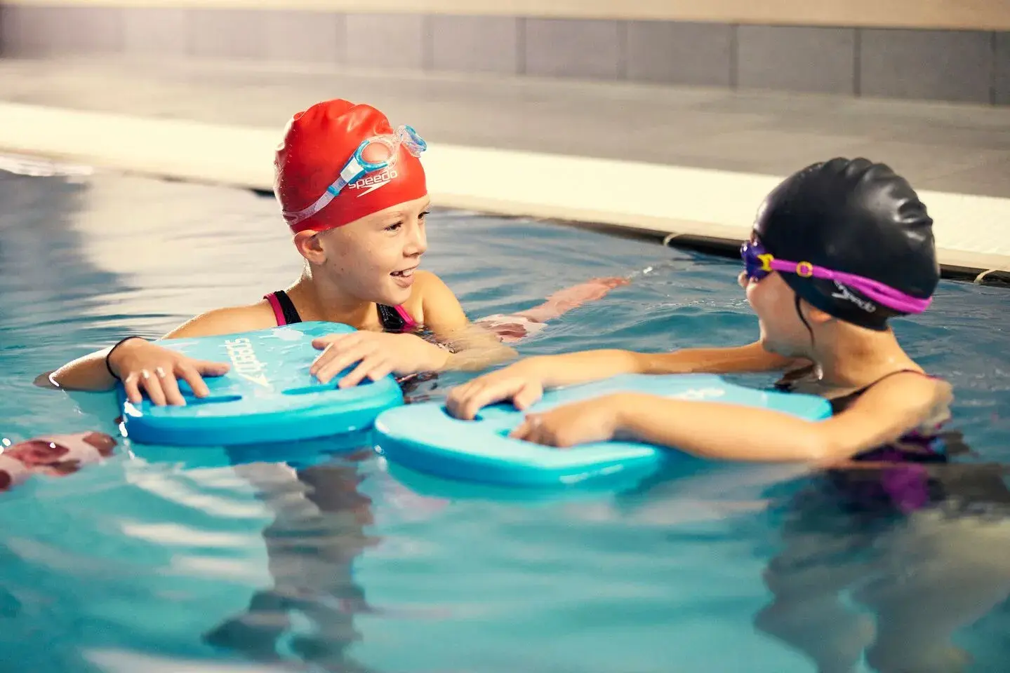 A young child being taught to swim by a David Lloyd swim instructor