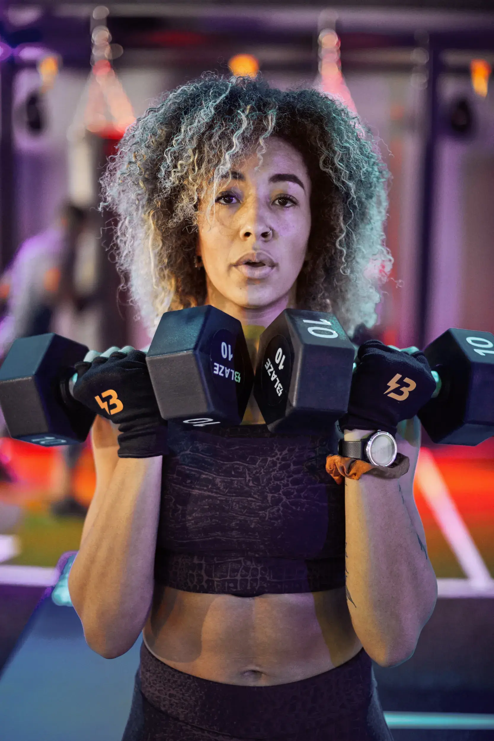 Lady lifting dumbbells in BLAZE