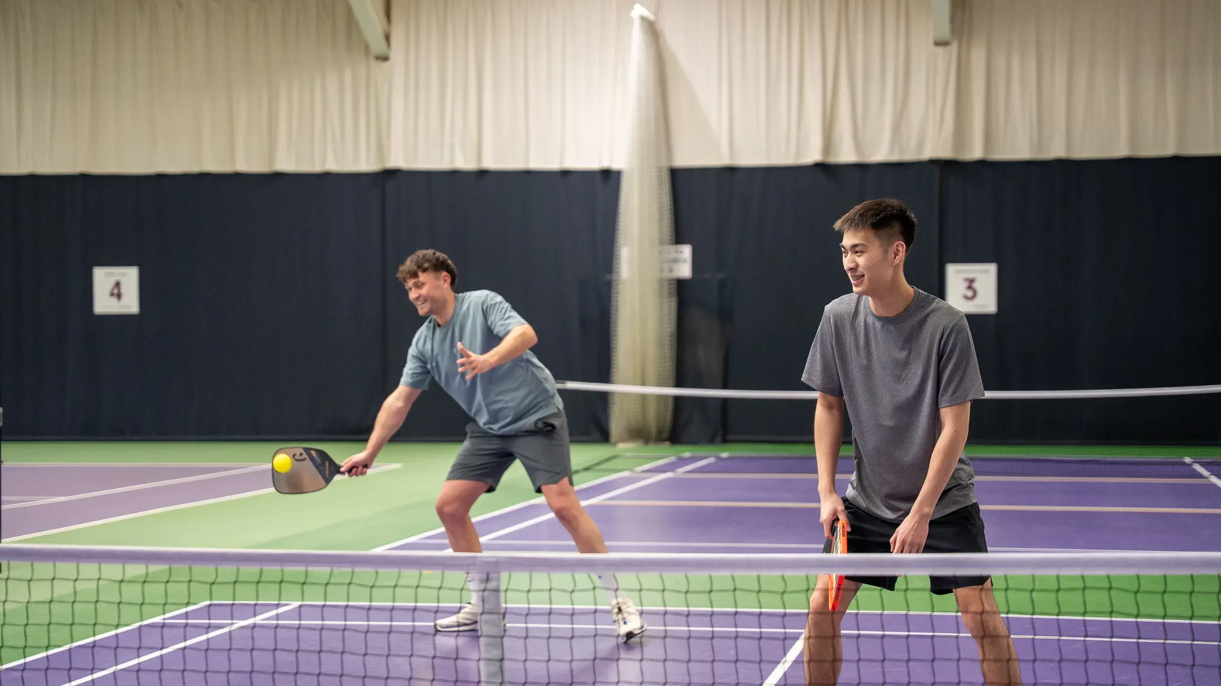 Teenagers playing tennis 
