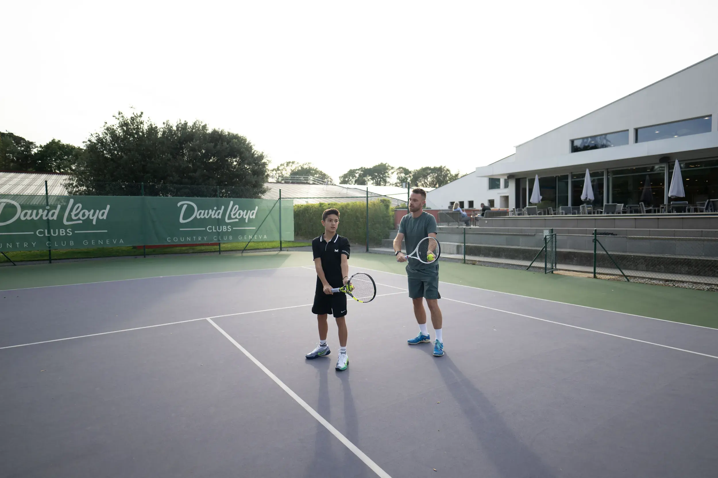 Children jumping holding tennis racquets