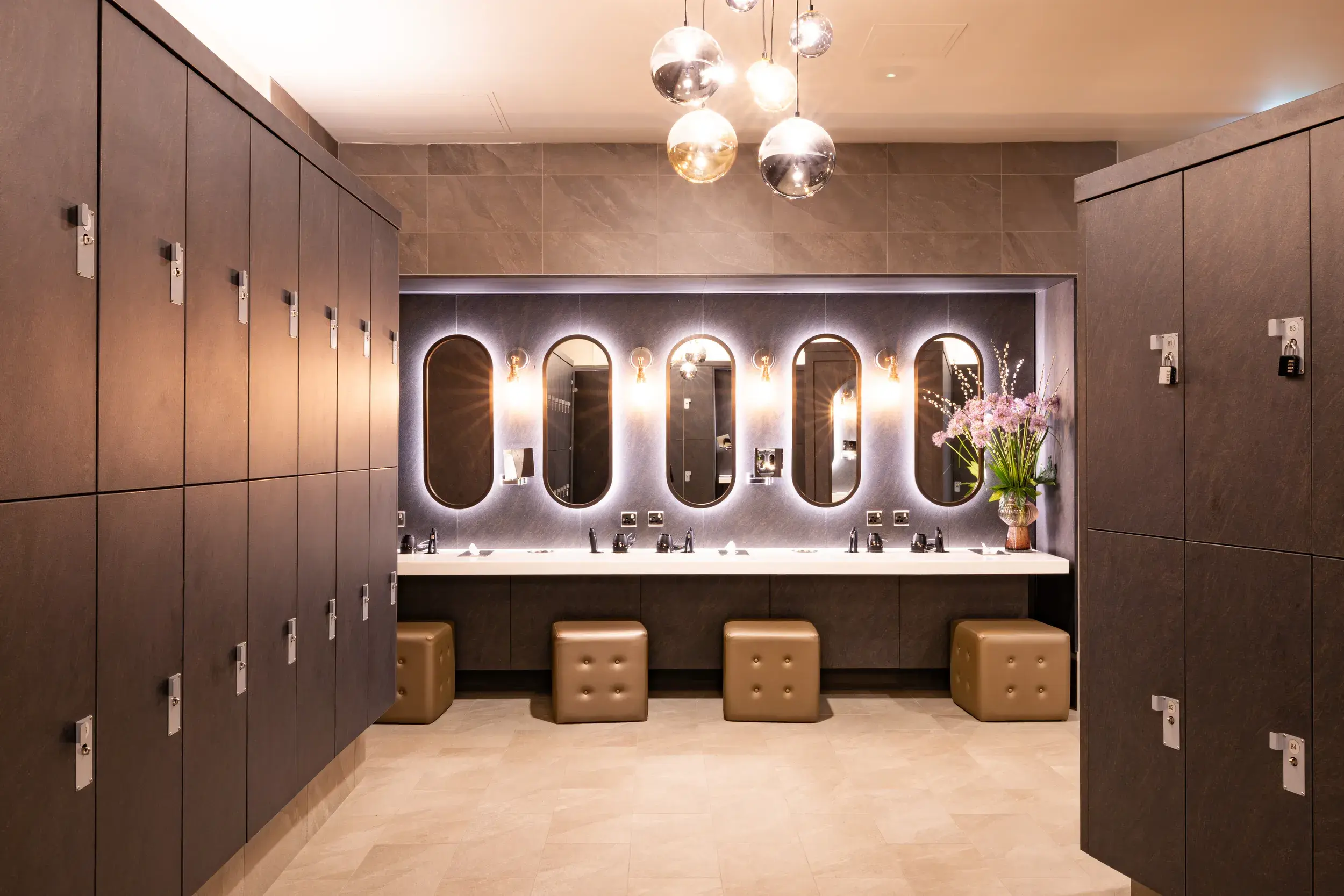 Vanity area with mirrors, stools and hairdryers
