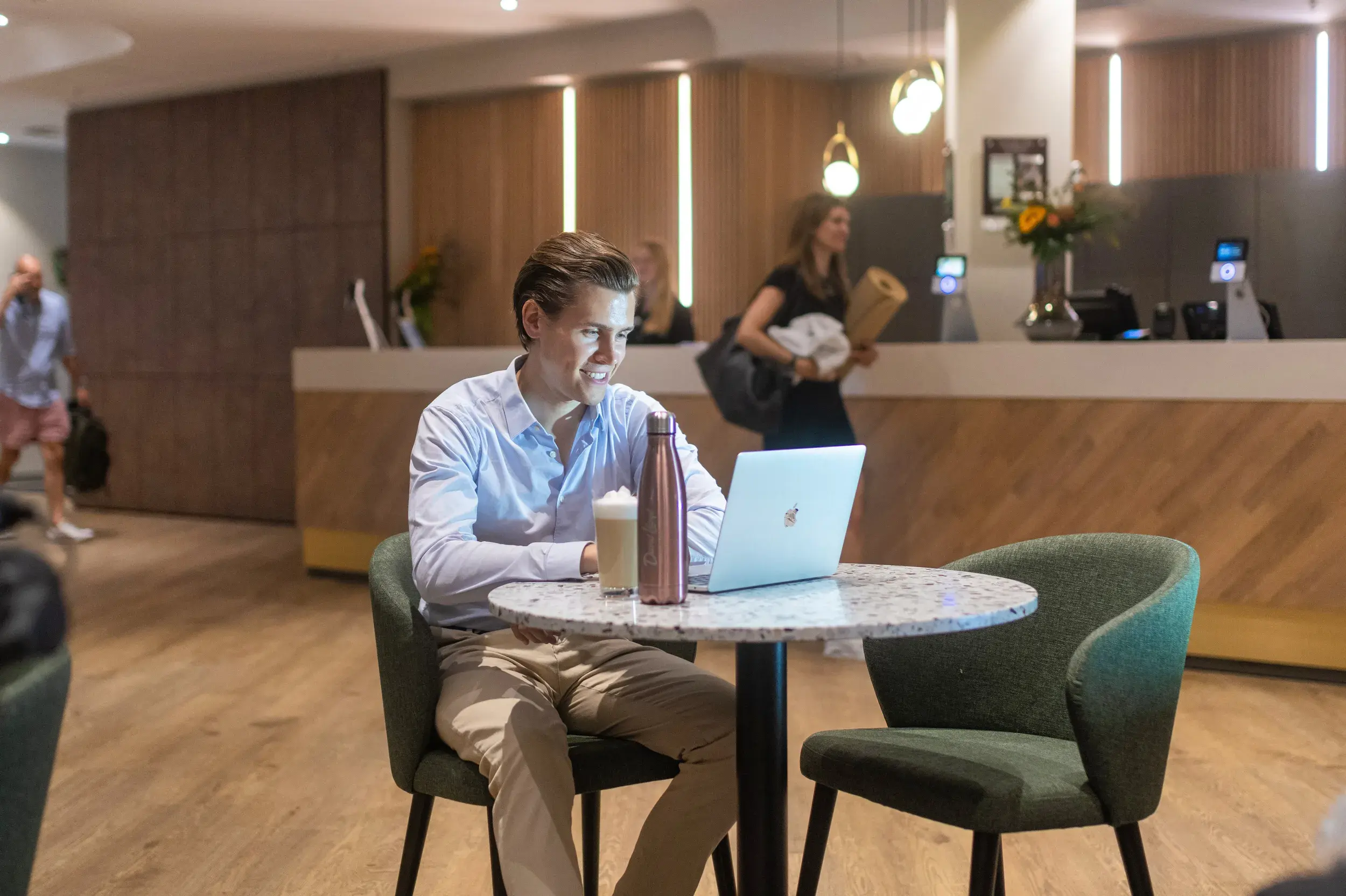 A man working on his laptop in David Lloyd Frankfurt's clubroom