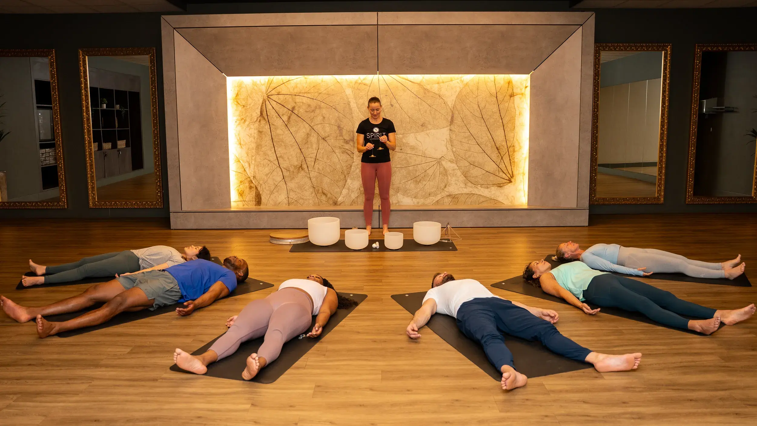 A Spirit class relaxing as the instructor provides a sound bath