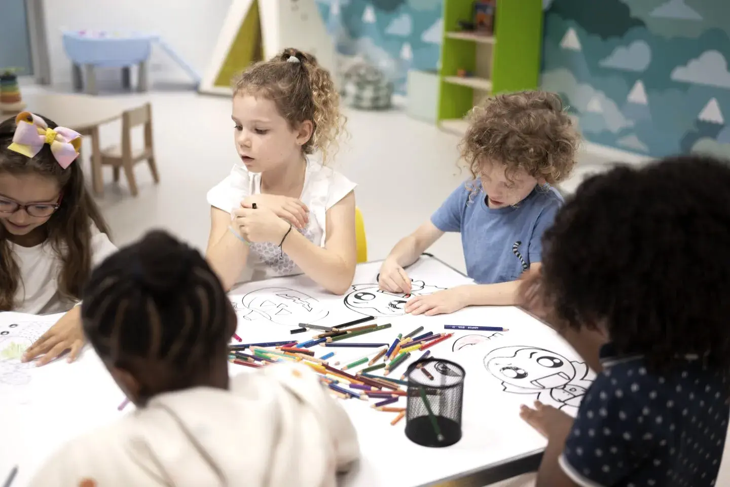 Children colouring at a table