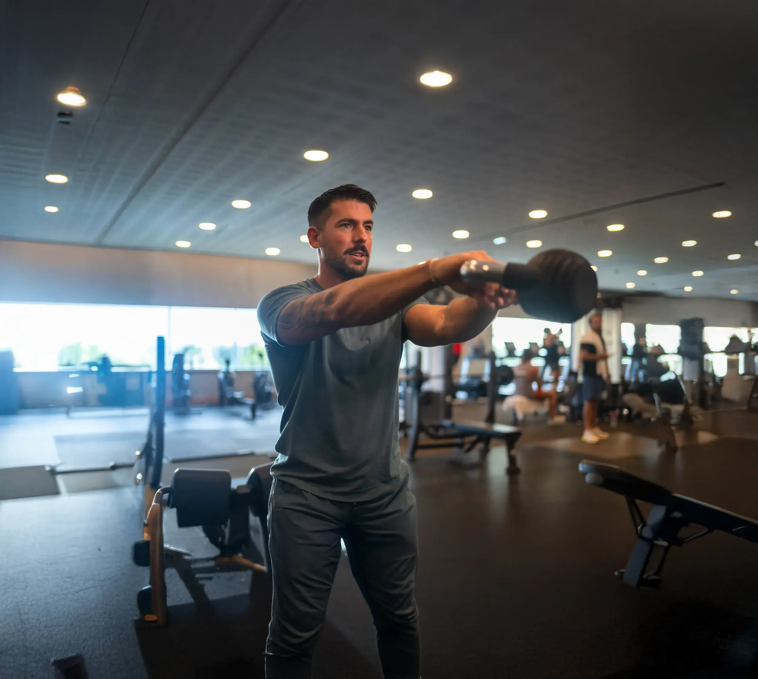 A man in the gym with a weight