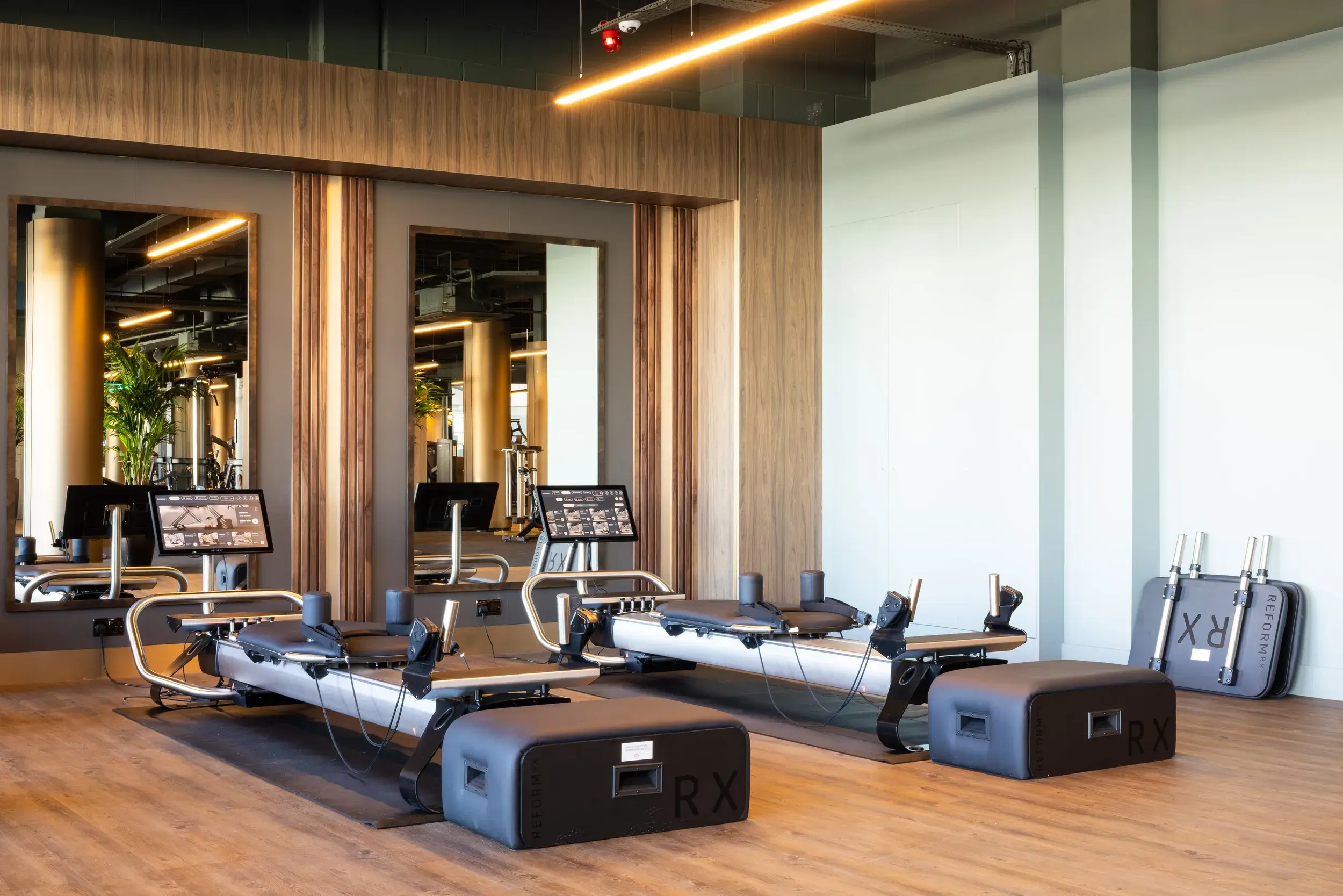 A man pushing a weight with his legs, working with a personal trainer