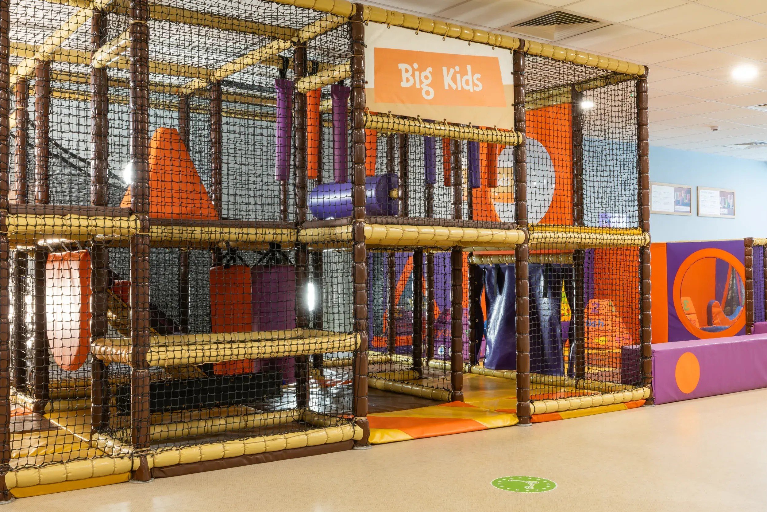 Children playing under a multicoloured tent