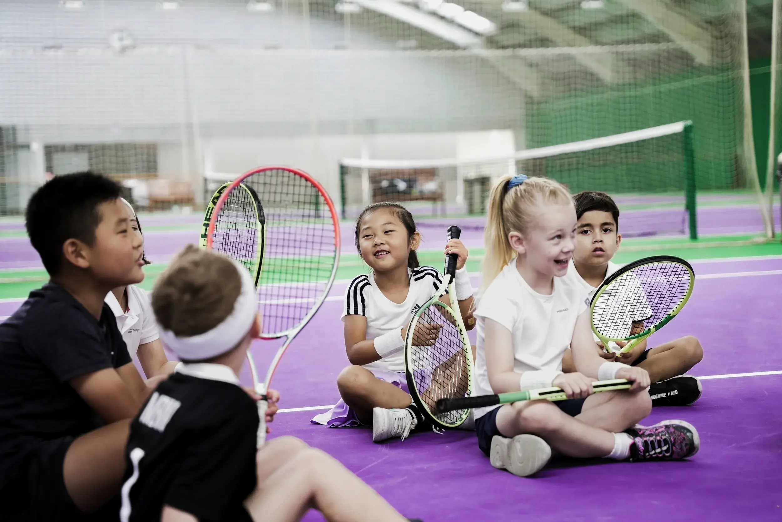 Children holding tennis racquets