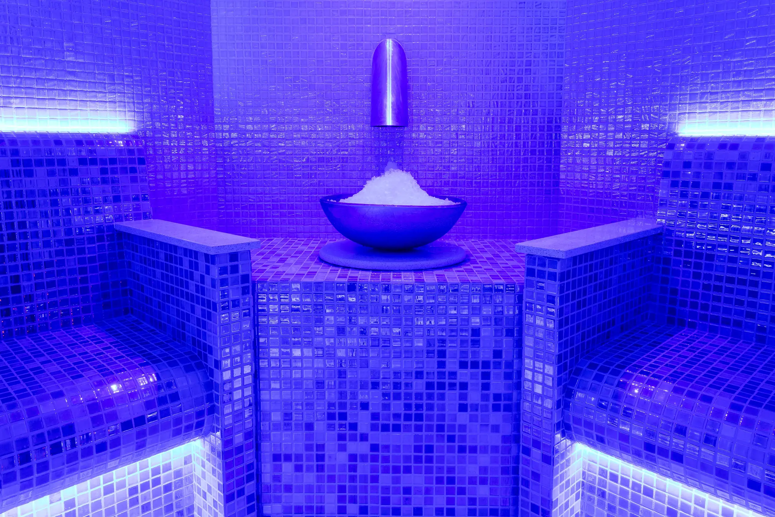 The ice cave, glowing blue, with a bowl of ice surrounded by shining tiles 