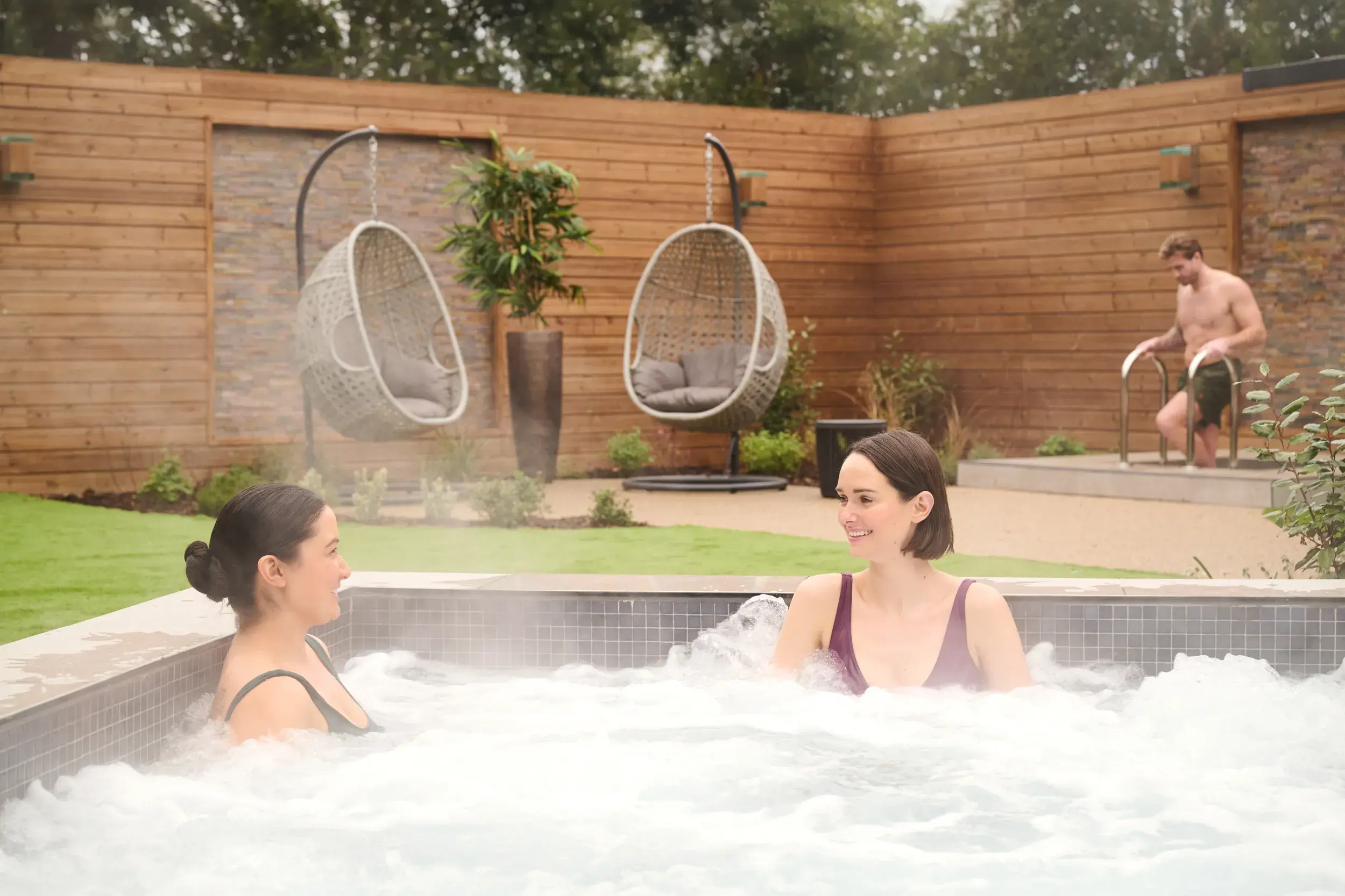 Two people relaxing in the tranquil surroundings of our Spa Garden