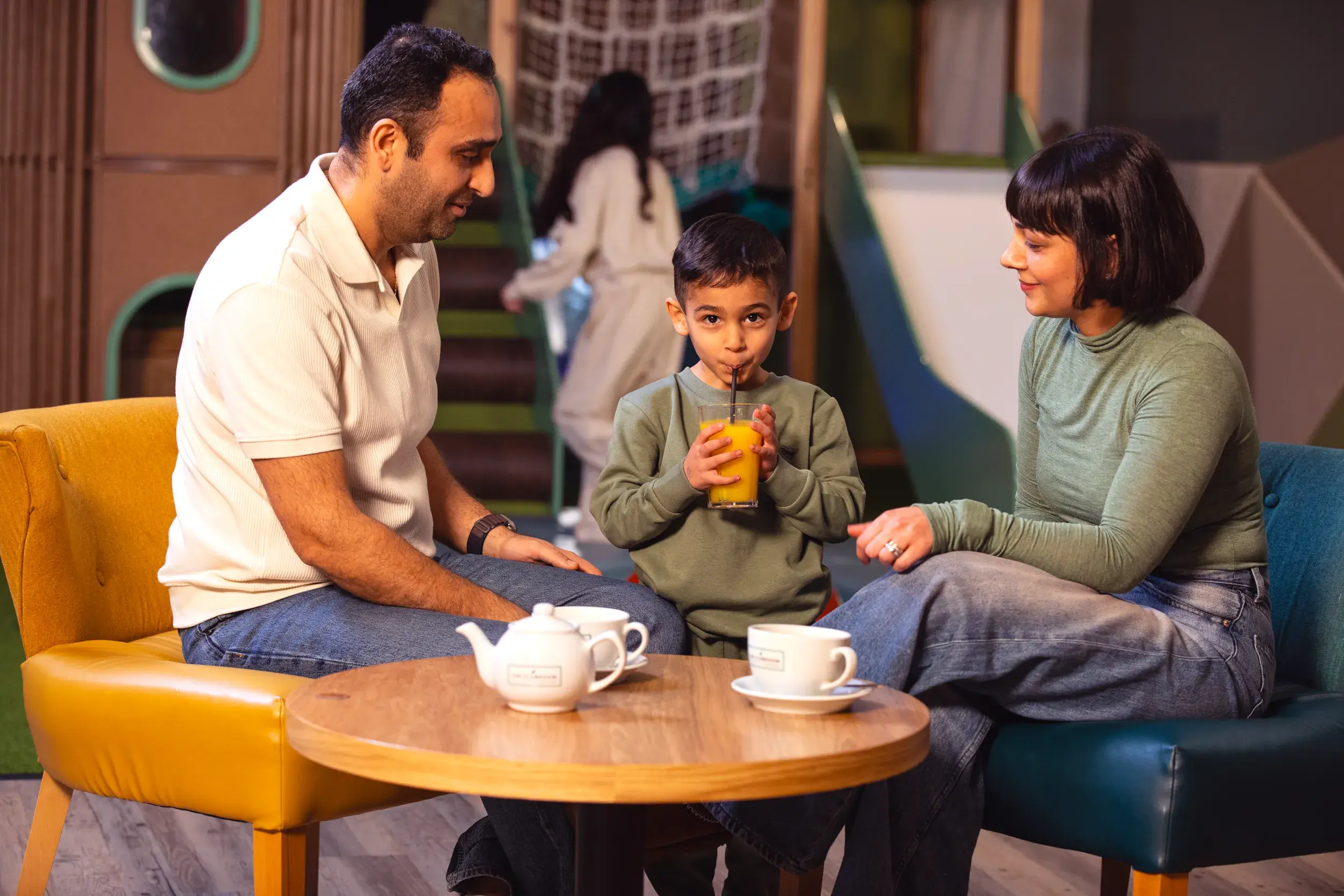A family enjoying a drink in the Clubroom together