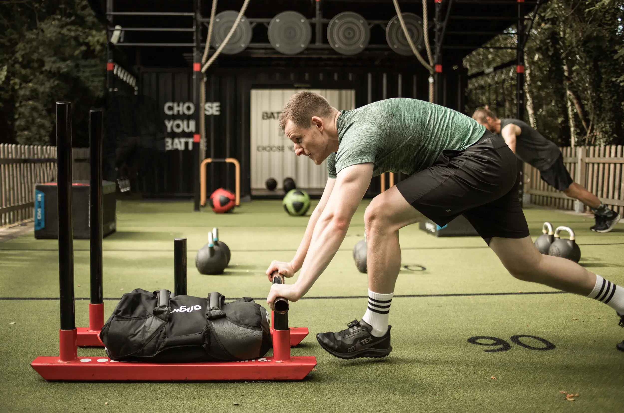 Two people climbing on the Battlebox frame