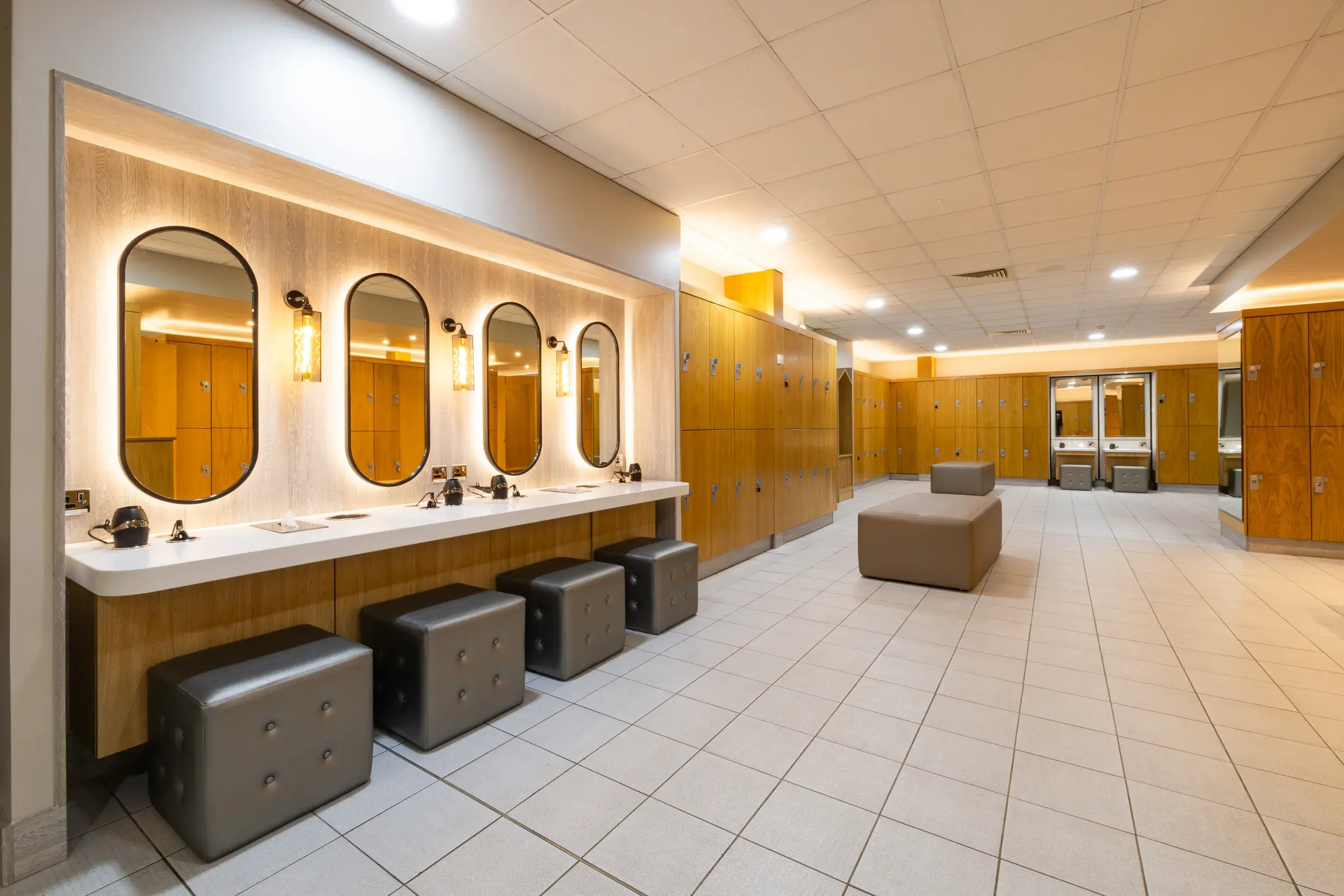 Spacious changing room with mirrors, hairdryers and lockers