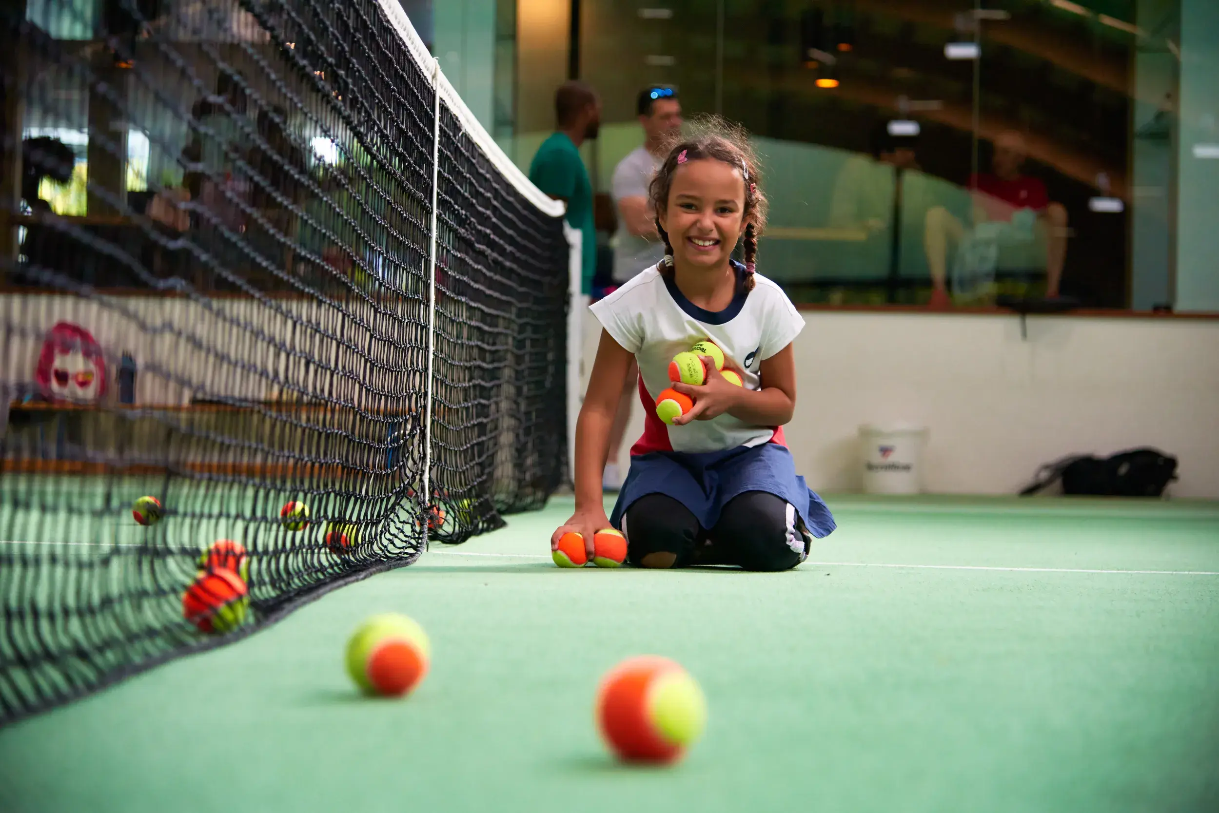 Kids throwing tennis balls