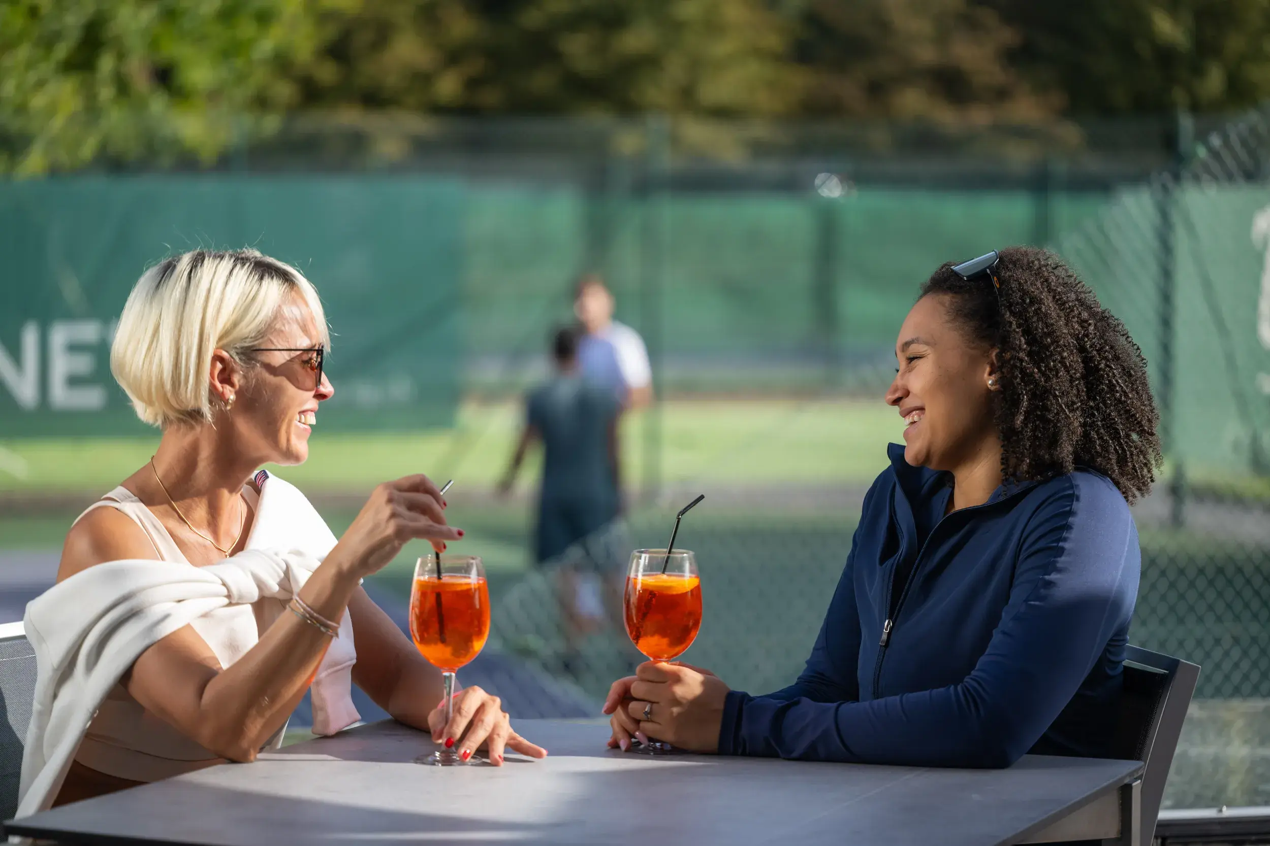 Two women enjoying a drink on the terrace