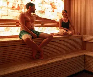 A man and a woman basking in the heat of the Himalayan salt sauna