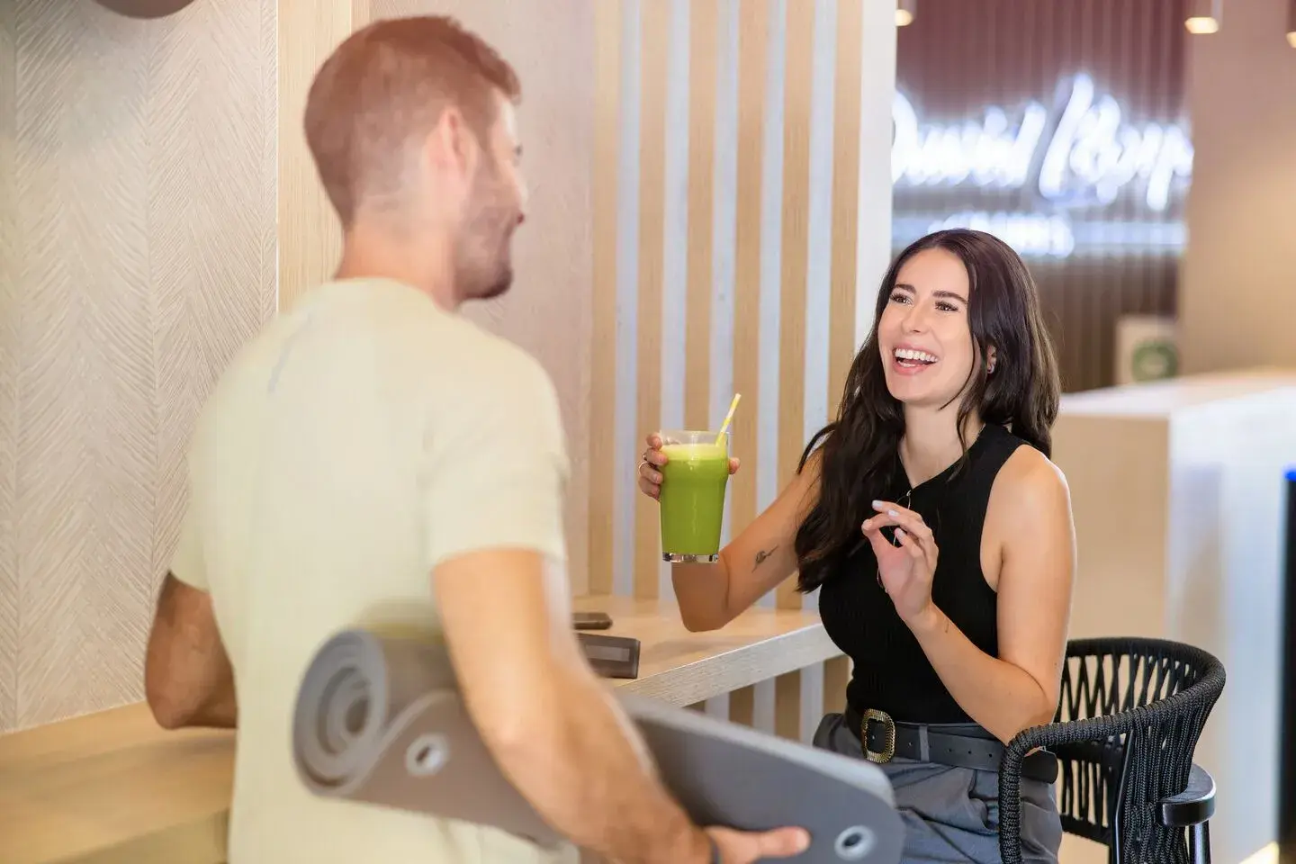 A man and woman enjoying a drink in the Clubroom