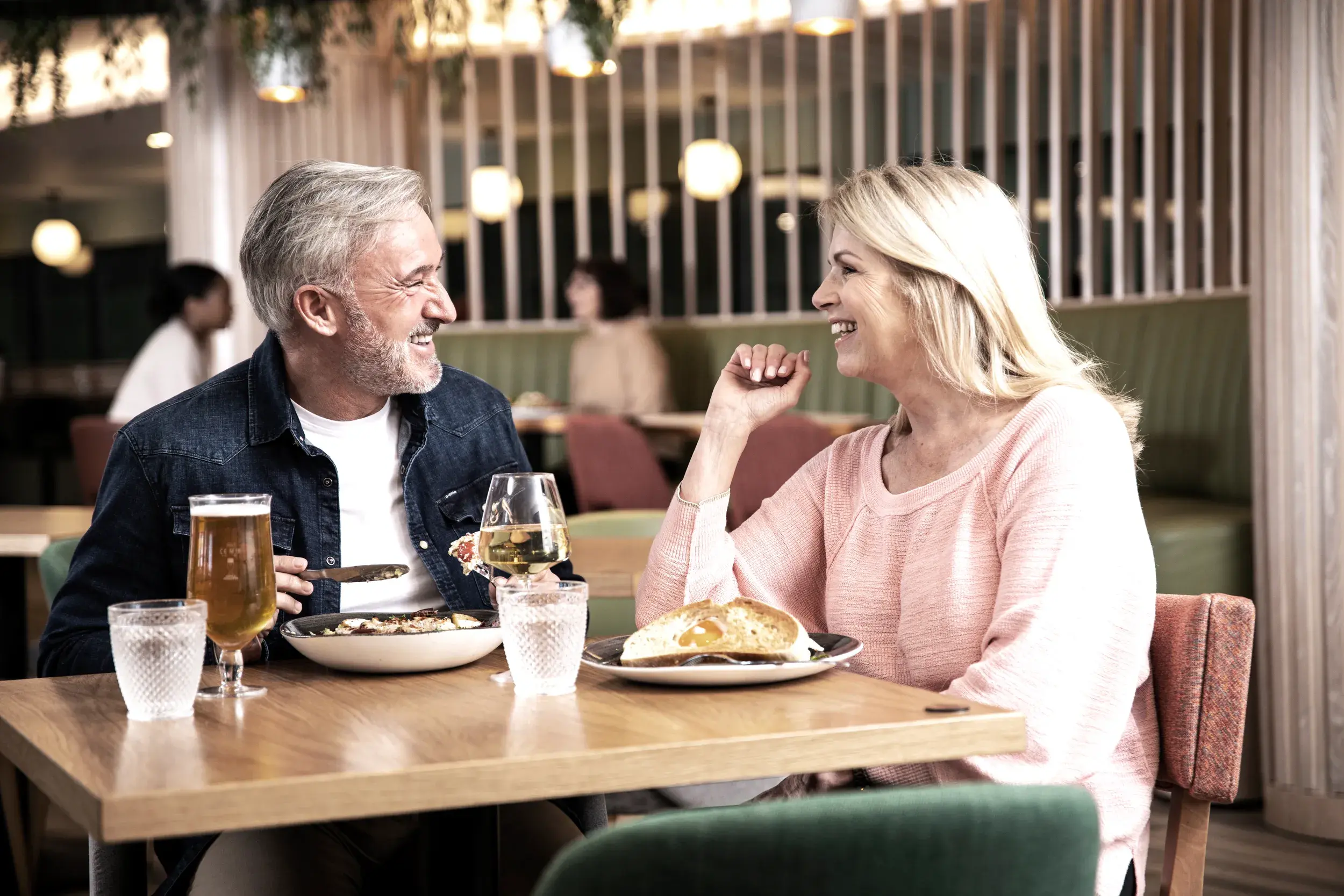 Two women enjoying a drink and a chat in the Clubroom