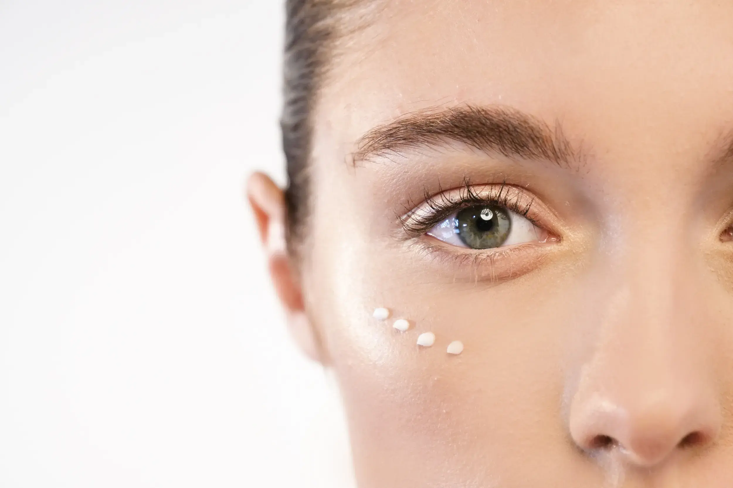 A woman with some eye cream
